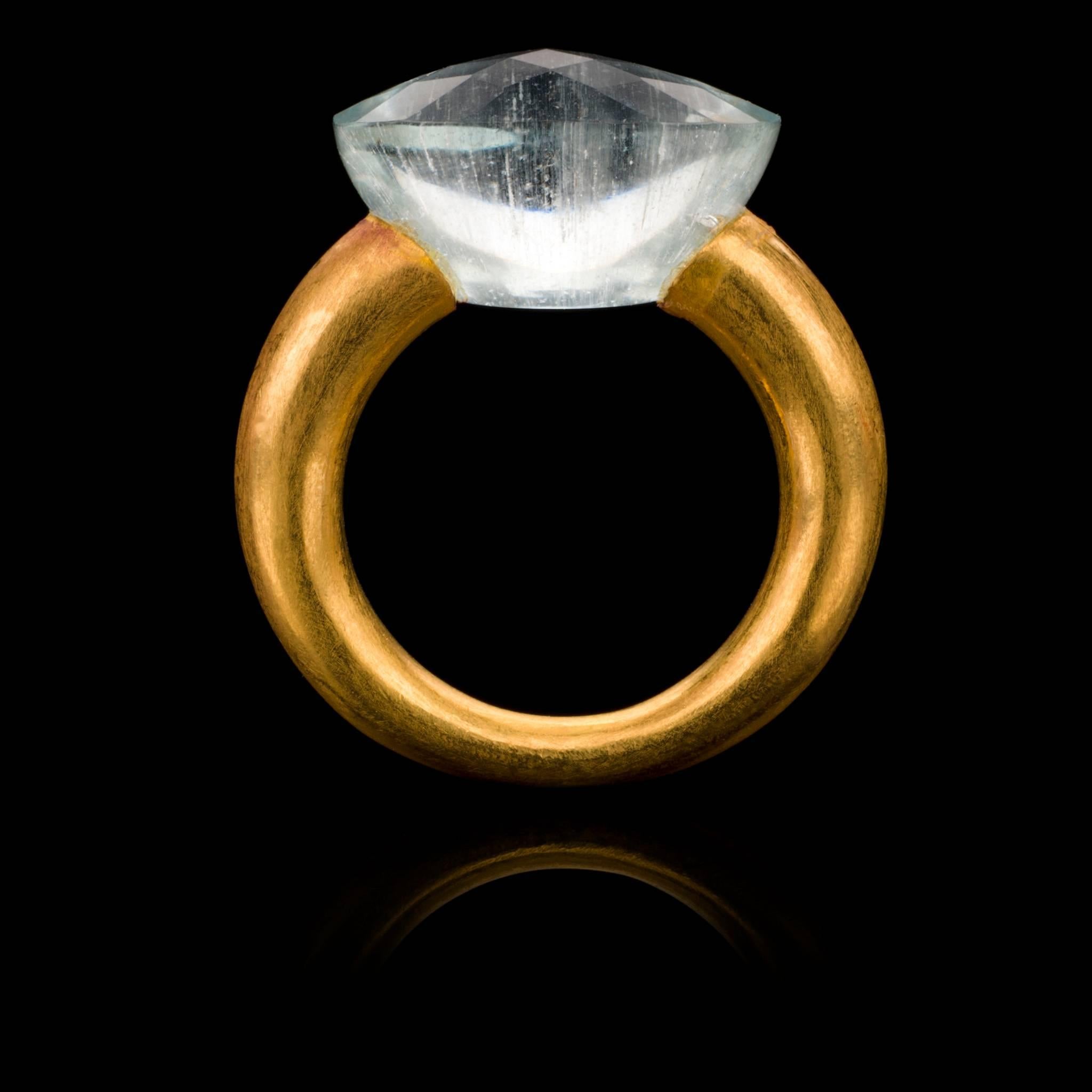 Unique 18 karat brushed gold ring holding a large, faceted oval cut aquamarine. The simplicity of the design puts the stone centre stage and gives it the opportunity to truly dazzle! The ring is hand made using ancient Indian techniques that have