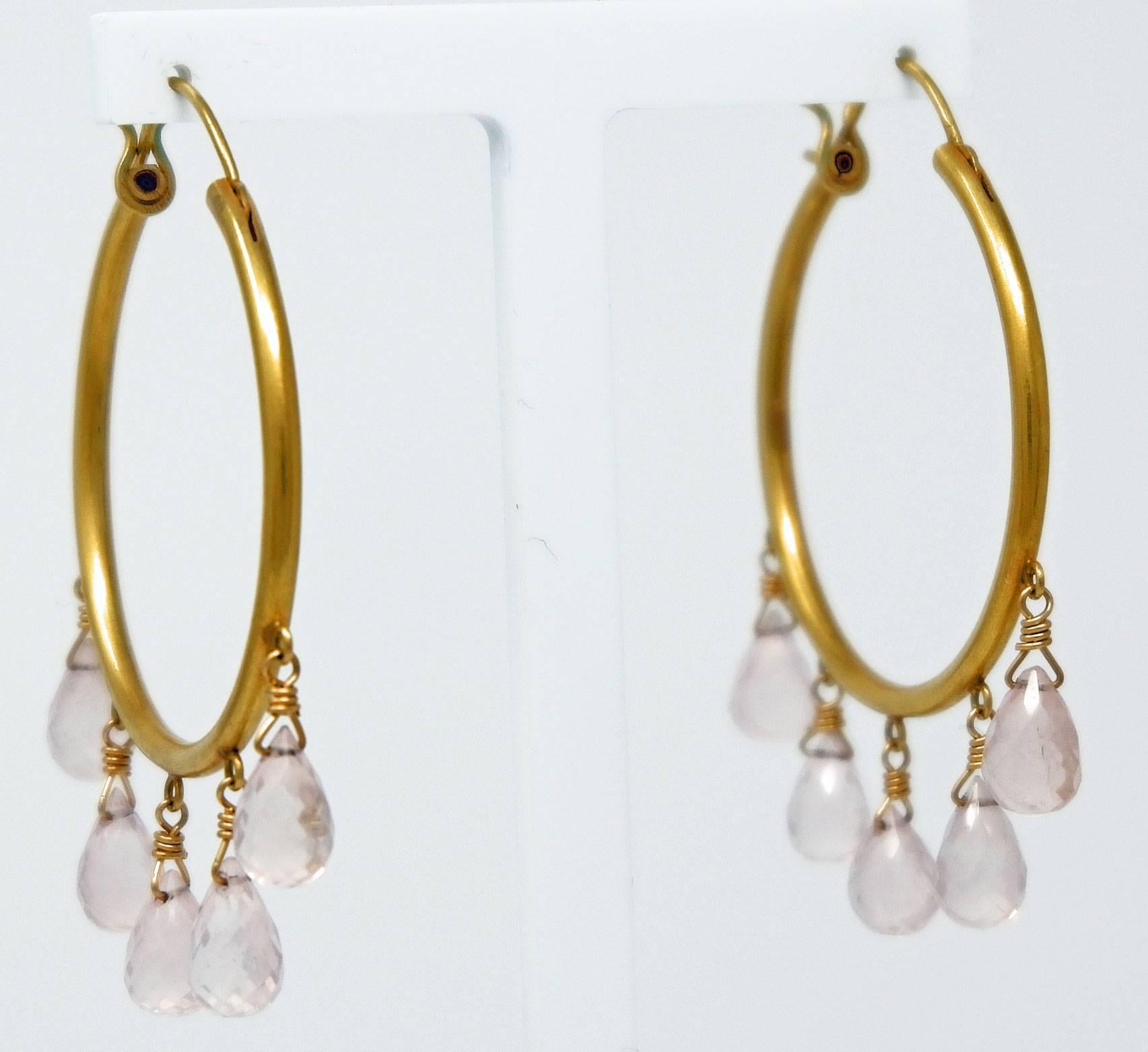 A pair of 18 karat brushed gold earrings with delicate rose quartz briolettes.  Dazzle with these large hoop earrings which look stunning day as well as night. The delicate rose quartz briolettes are translucent and slightly milky in colour adding a