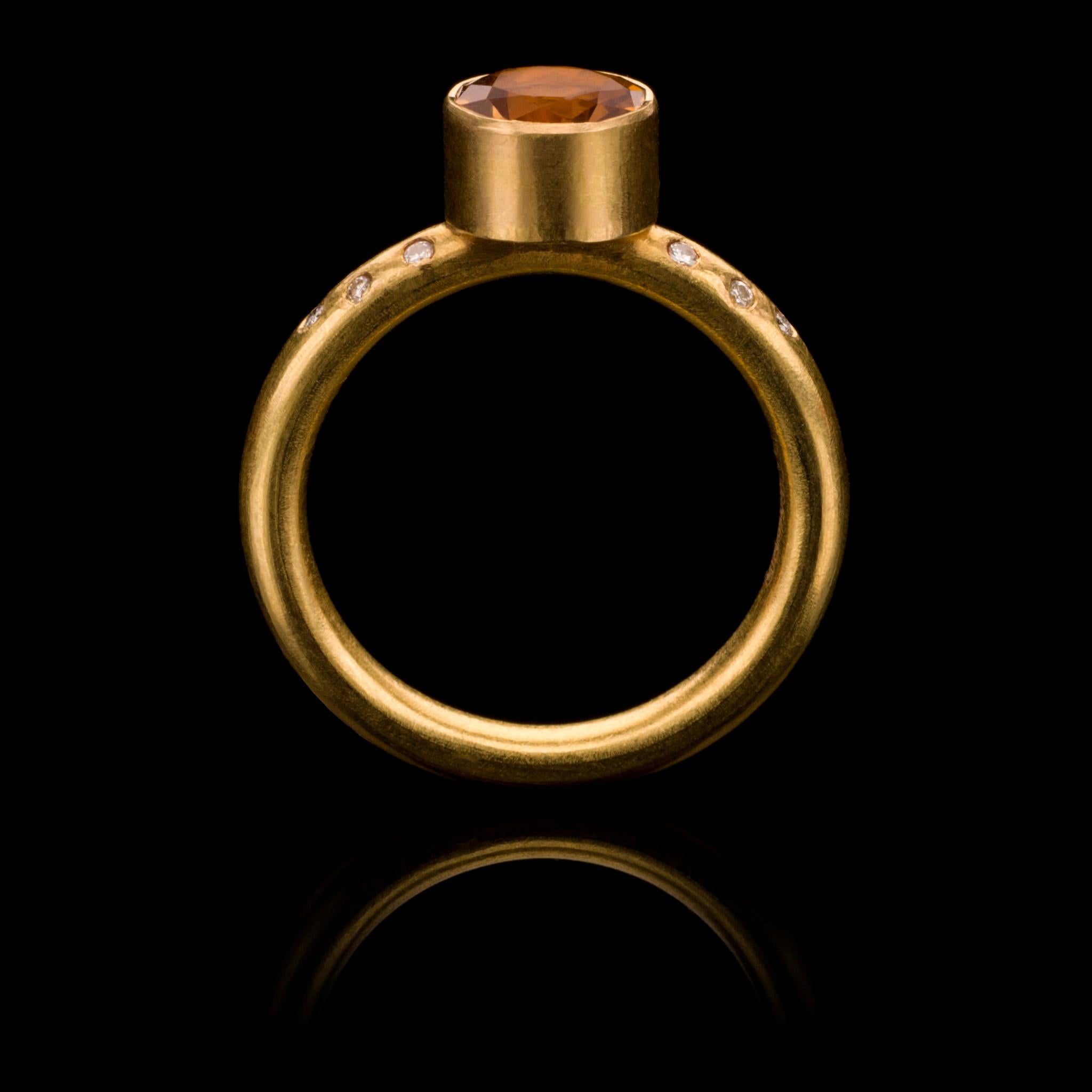 A chic, hand crafted 18 karat matte gold stacking ring with a round cut, vibrant citrine flanked by five diamonds either side. Size:  UK M/N US 6.75 Europe 53. The ring can be resized. Wear it on its own or with other rings from the collection as