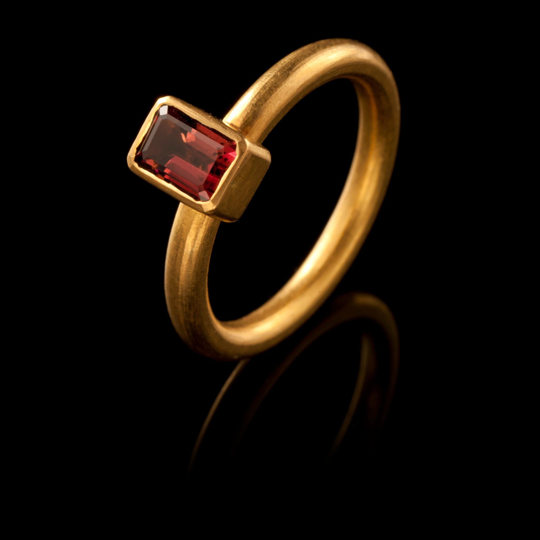 A chic, hand crafted 18 karat matte gold stacking ring with an emerald cut light brownish/pink tourmaline. Size: UK: O/P US: 7.75 Europe: 55.5 The ring can be resized. Wear it on its own or with other rings from the collection as shown on our model.