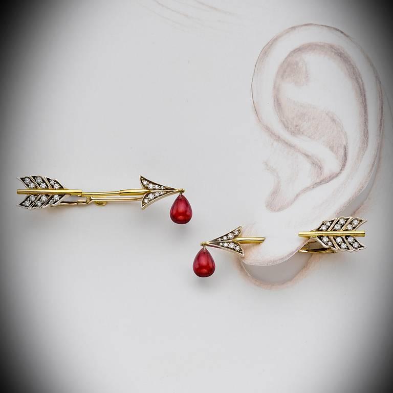 Earrings designed to appear piercing the flash of the ear lobe. Made of with 18 k gold topped with blackened silver and set with diamonds. Ruby blood drop 2.5 ct.
Brand New Never Been Worn.