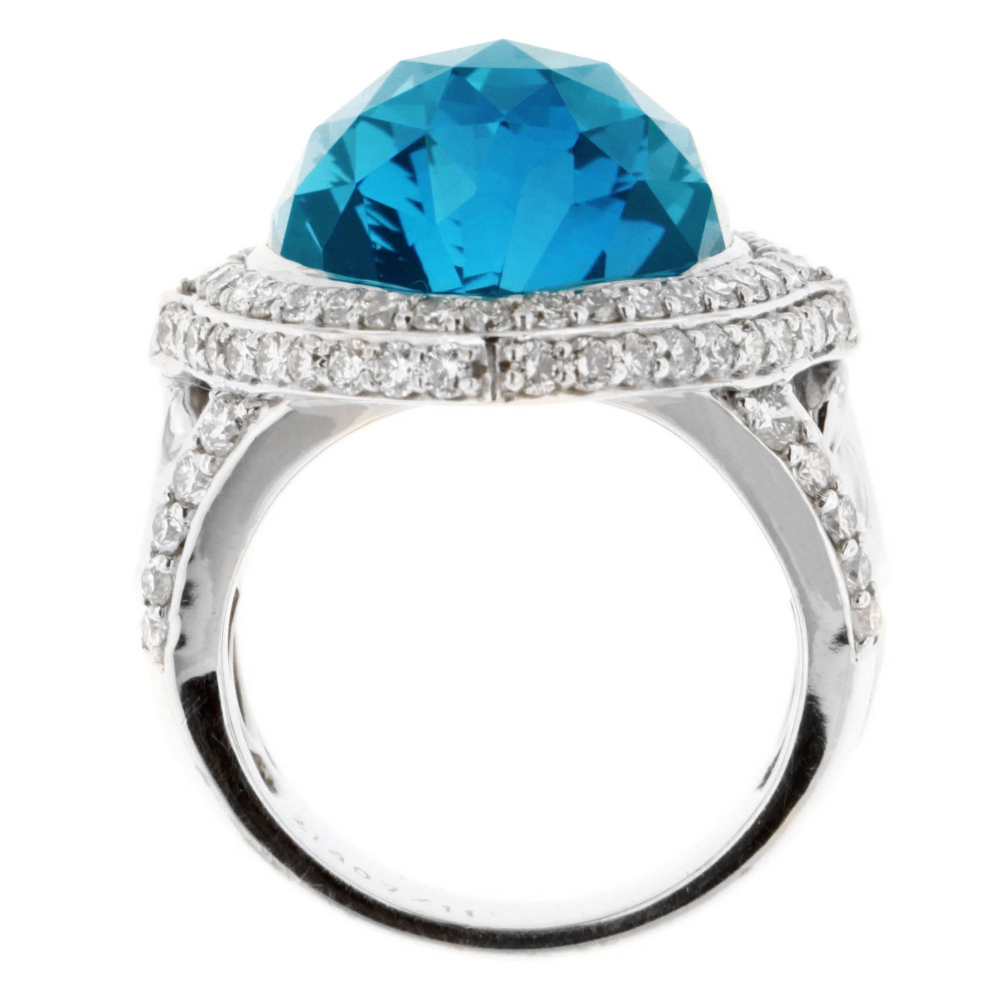 Shine in the vitreous luster of Zorab's striking London Blue Topaze cocktail ring weighing  22.90 Carats, surrounded by 1.96 Carats of White Diamonds and set on 18 Karat Gold and Palladium.

This item has a serial number and bears the stamp of