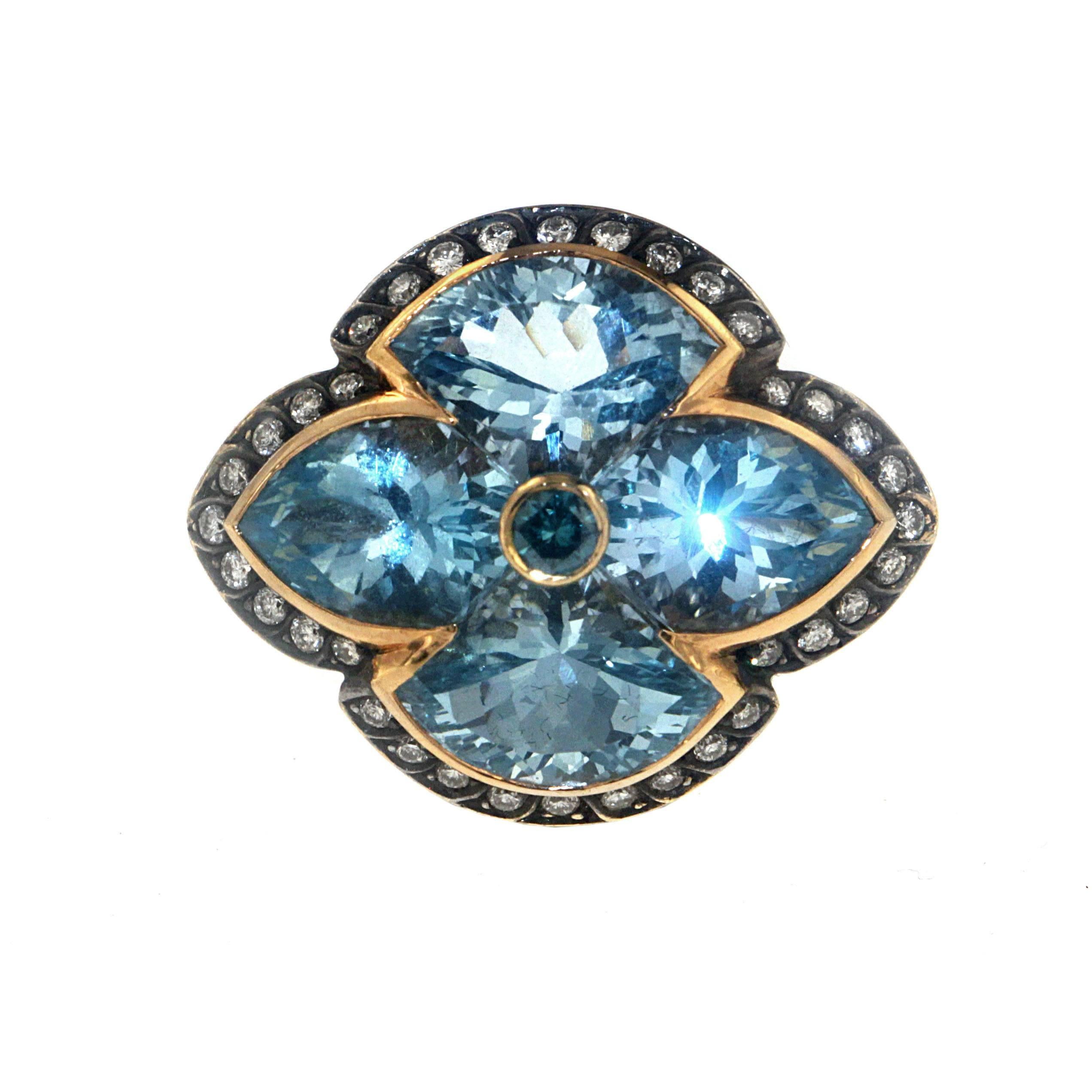 This stately Zorab Creation original features 4 Blue Topaz center stones totaling 19.60 carats. Surrounded by 5.23 carats of Blue Sapphire and 0.62 carats of White Diamonds, this stunning 18 Karat Gold cocktail ring stands in a class by itself.