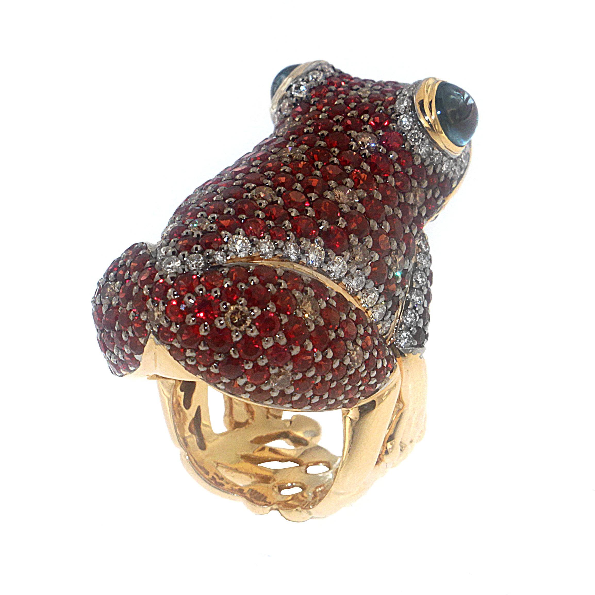 Delight in your love of animals with Zorab's hand-crafted charming Red Sapphire frog. The 18 Karat Gold ring is set with 13.92 Red Sapphires and accented with 1.11 carat Brown Diamonds, 1.38 carat White Diamonds, and 3.22 carat Blue Natural