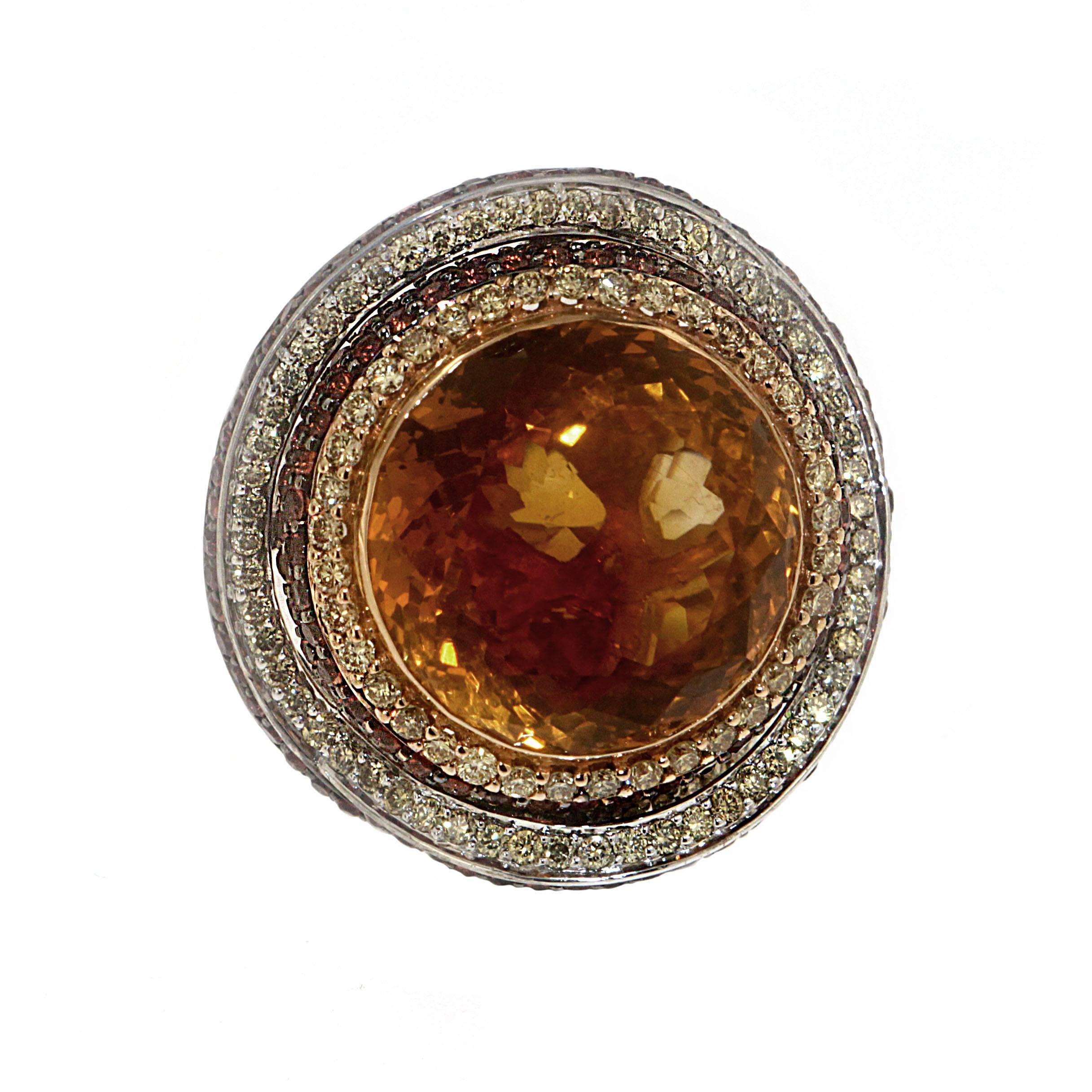 Make a bold statement with Zorab's smokey 16.55 Citrine Quartz contemporary cocktail ring. Orange Sapphires (2.60 Carats) and Yellow Diamonds (1.25 Carats) swirl around the eye-catching center stone with a dazzling effect!

This item has a serial