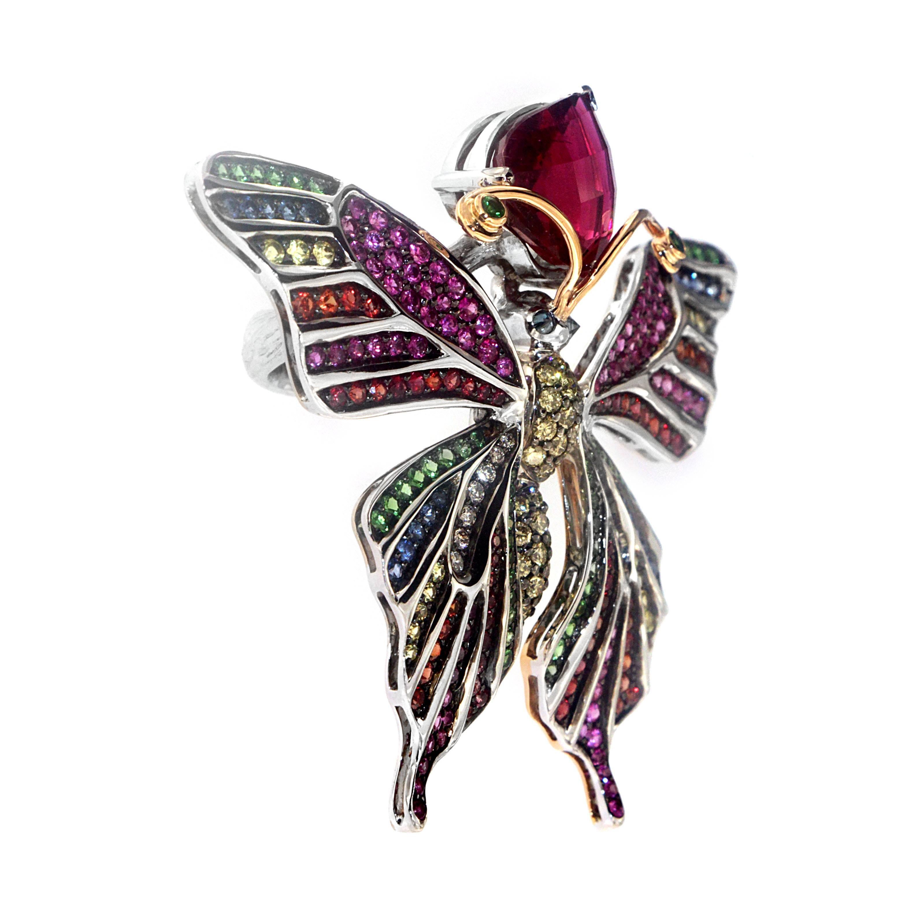 The delicate creature with painted wings of multi-colored sapphire (4.36 carats), Tsavorite Garnet (1.05 carats), White Diamonds (0.25 carats) and Blue Diamonds (0.06 carats) has gently landed on a Ruby (9.35 carats) flower. Zorab's exquisite 18 Kt