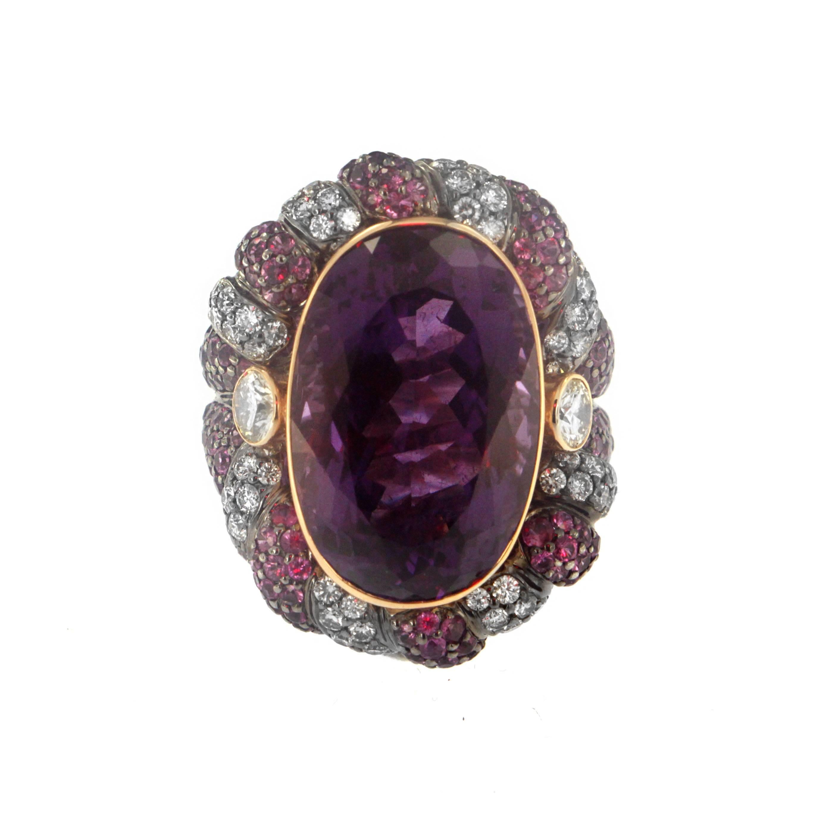 Raise a glass to 19.89 Carats of Amethyst Quartz faceted into this magnificent jewel as the center stone for Zorab's glamorous cocktail ring.  Rimmed Pinks Sapphires (2.81 CT),  White Diamonds (1.77 CT) and set on 18 Karat Gold and Palladium, this