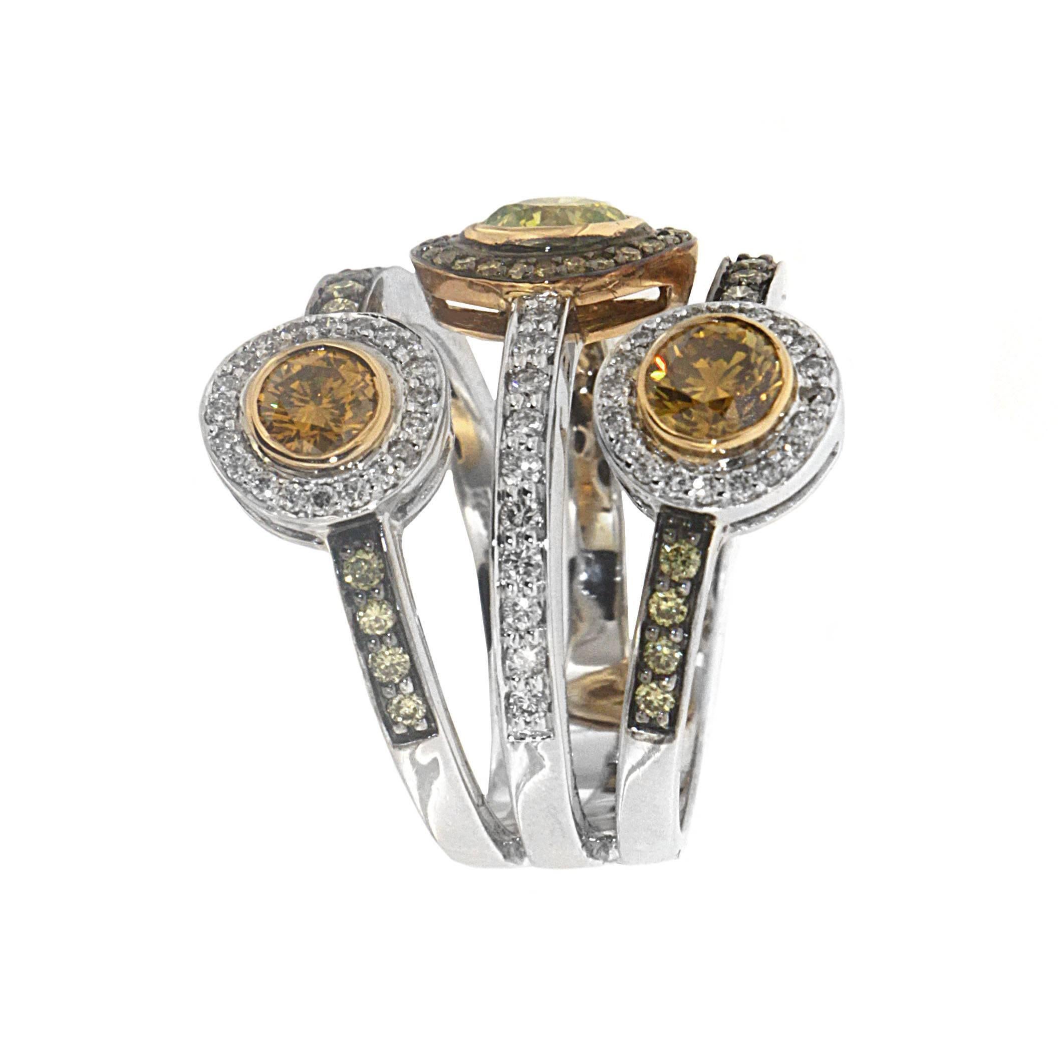 Zorab's distinctive ring depicting a set of three separate bands joined at the base create a superb trinity. Each band features a center stone ( 1.52 carats of Fancy Diamond and 1/35 carats of Yellow Sapphires). This uncommon halo ring with a
