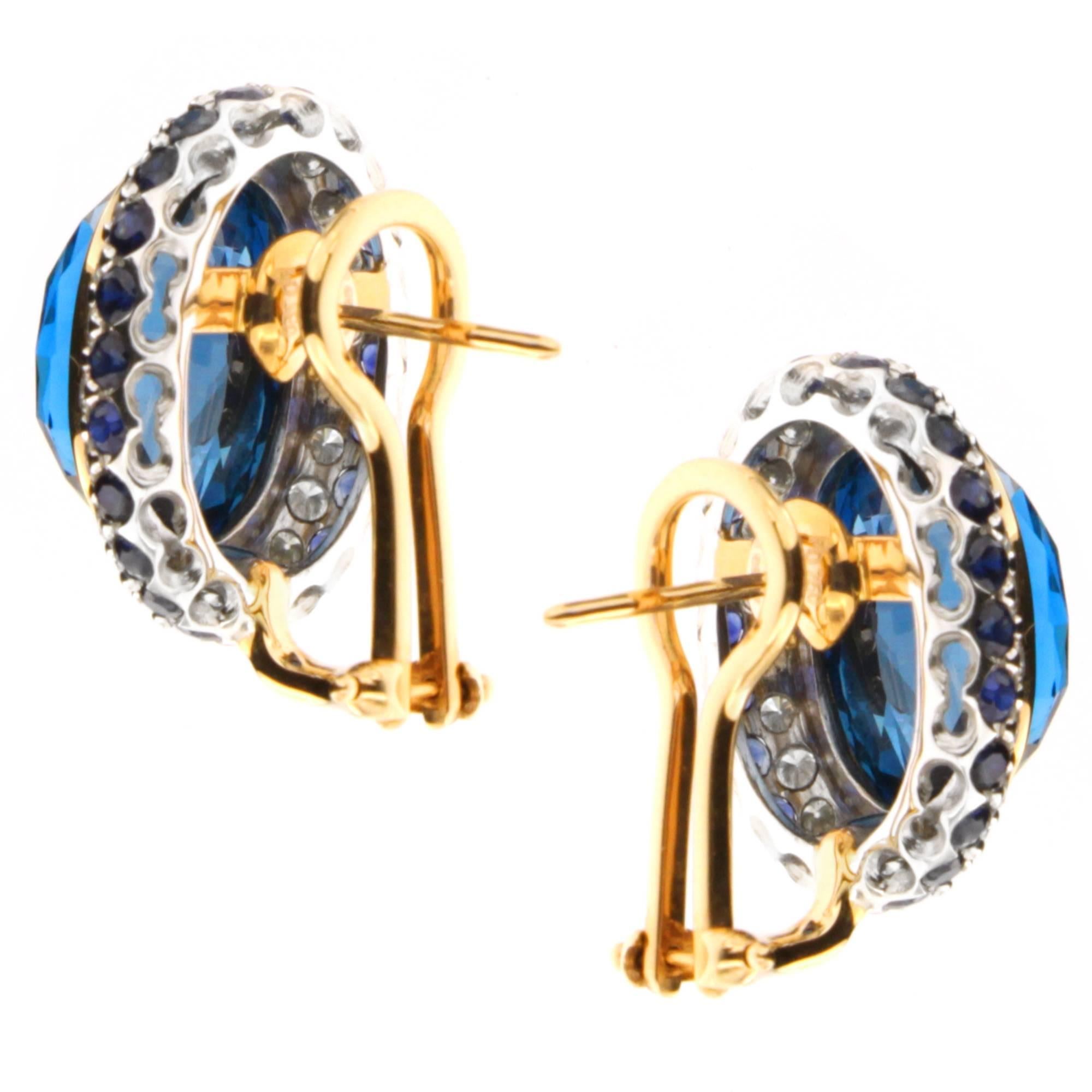 Make a lasting impression with Zorab's faceted 18.69 Ct Blue Topaz elegant earrings, set with 2.17 Carats of Blue Sapphire and 1.15 Carats of White Diamonds on 18 Karat Gold and Palladium. The piece-de-resistance is fitted with posts and Omega style