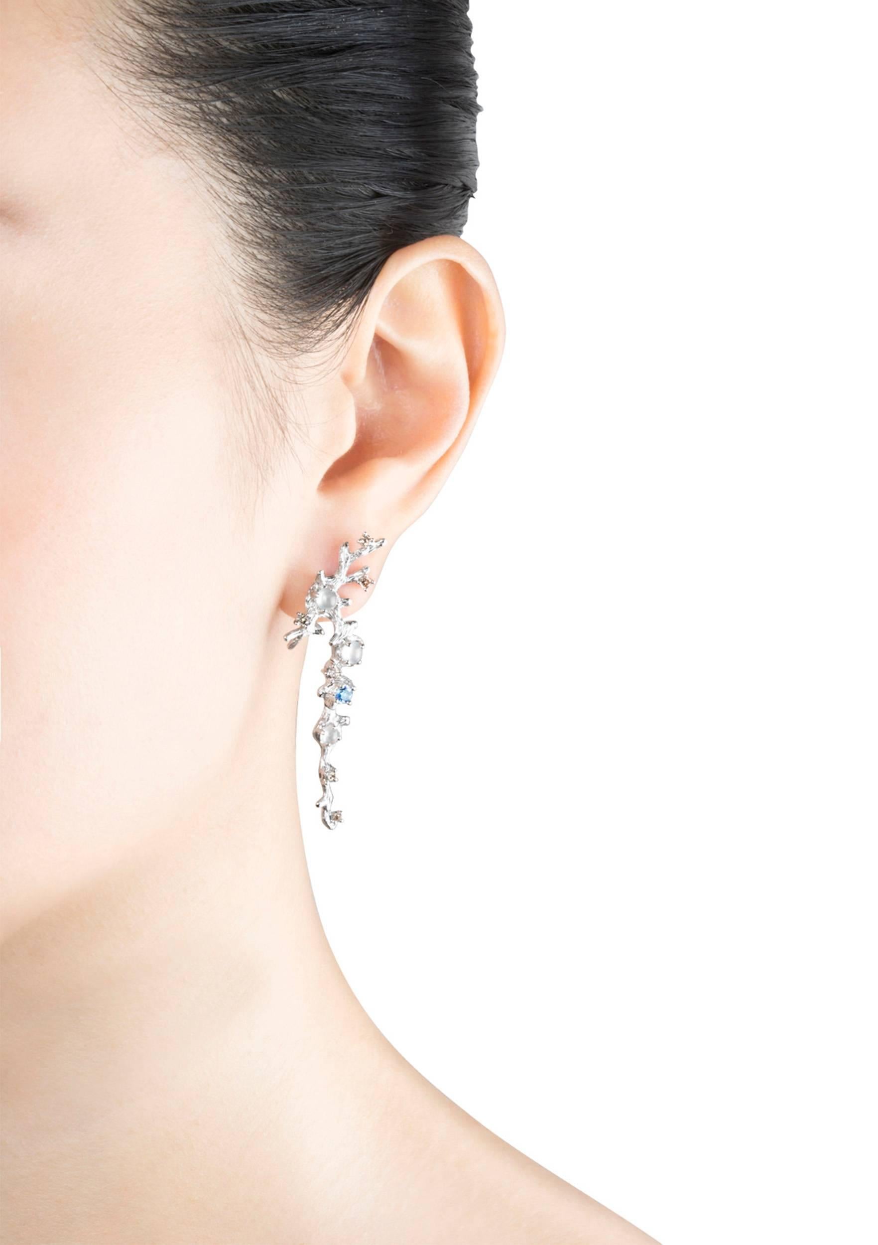 The distinctive finish of these 18K white gold earrings is inspired by glistening dewdrops at dawn. Featuring icy jade, fancy diamonds and sapphires, their simple yet stunning structure sparkles beautifully, embracing the excitement of a new day,