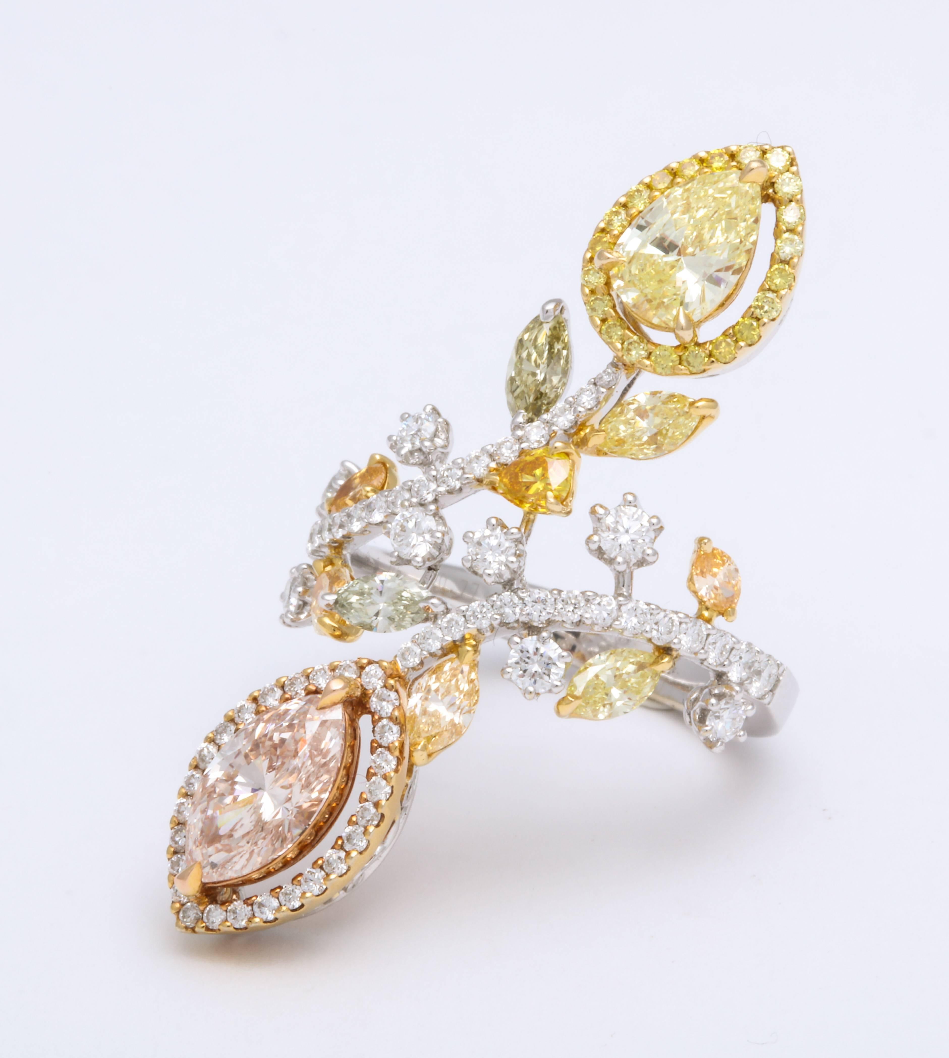 On the opposite 2 ends of this contemporary asymmetric bypass ring are mounted GIA certified marquise diamond: 0.92 carats, color Fancy Light Pink Brown set upon 18K rose gold diamond halo AND pear shaped diamond: 0.59 carats, fancy yellow