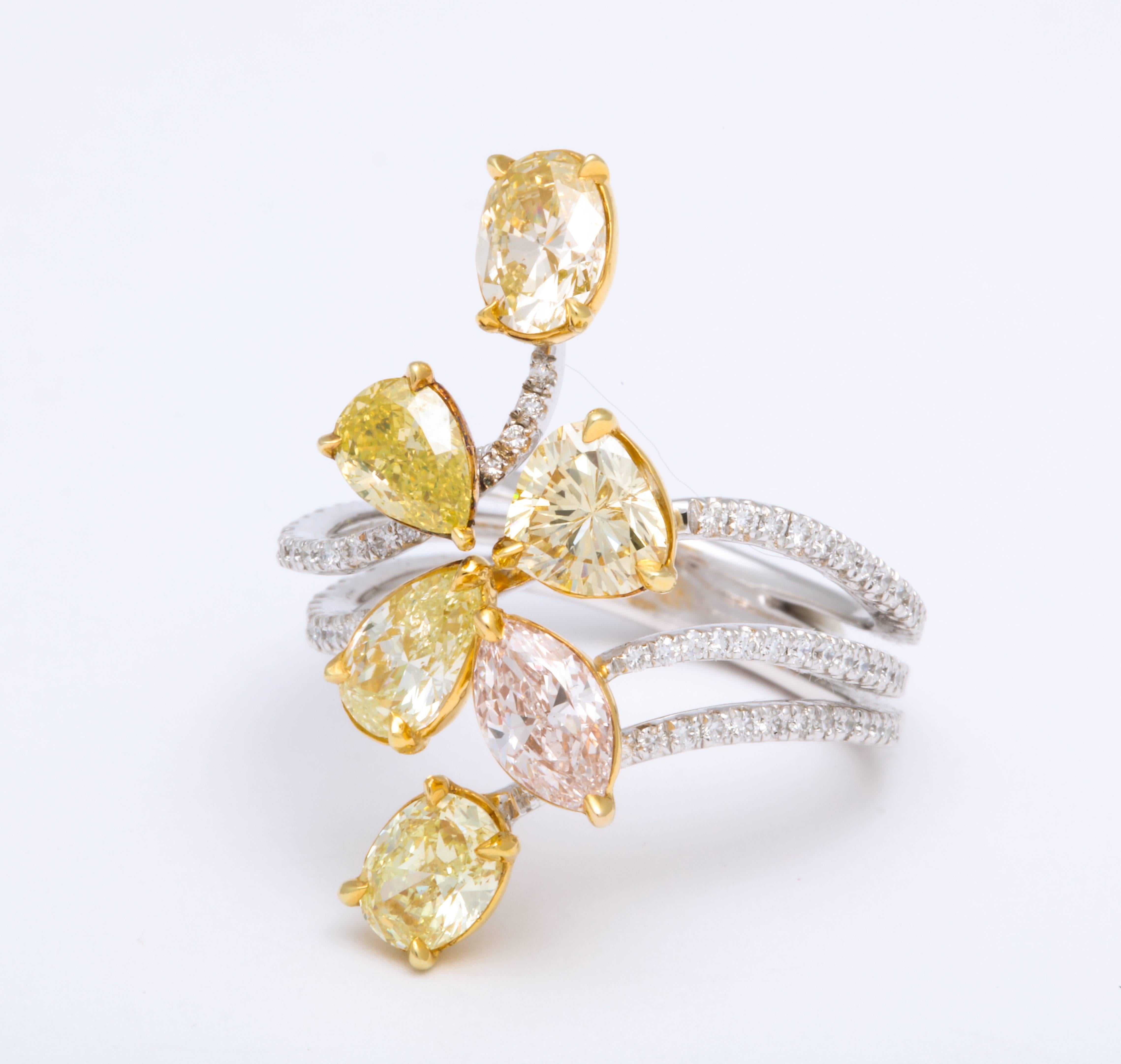 Free-form cluster of six fancy shape, natural multi color diamonds weighing 3.17 carats, prong-set on 18K Yellow Gold floating on contemporary 18K White Gold triple fork shank partially set with micro pave-set diamonds: 0.40 carats. Made to fit a