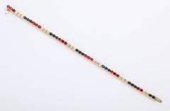 Diamond, Ruby and Sapphire Yellow Gold Tennis Bracelet