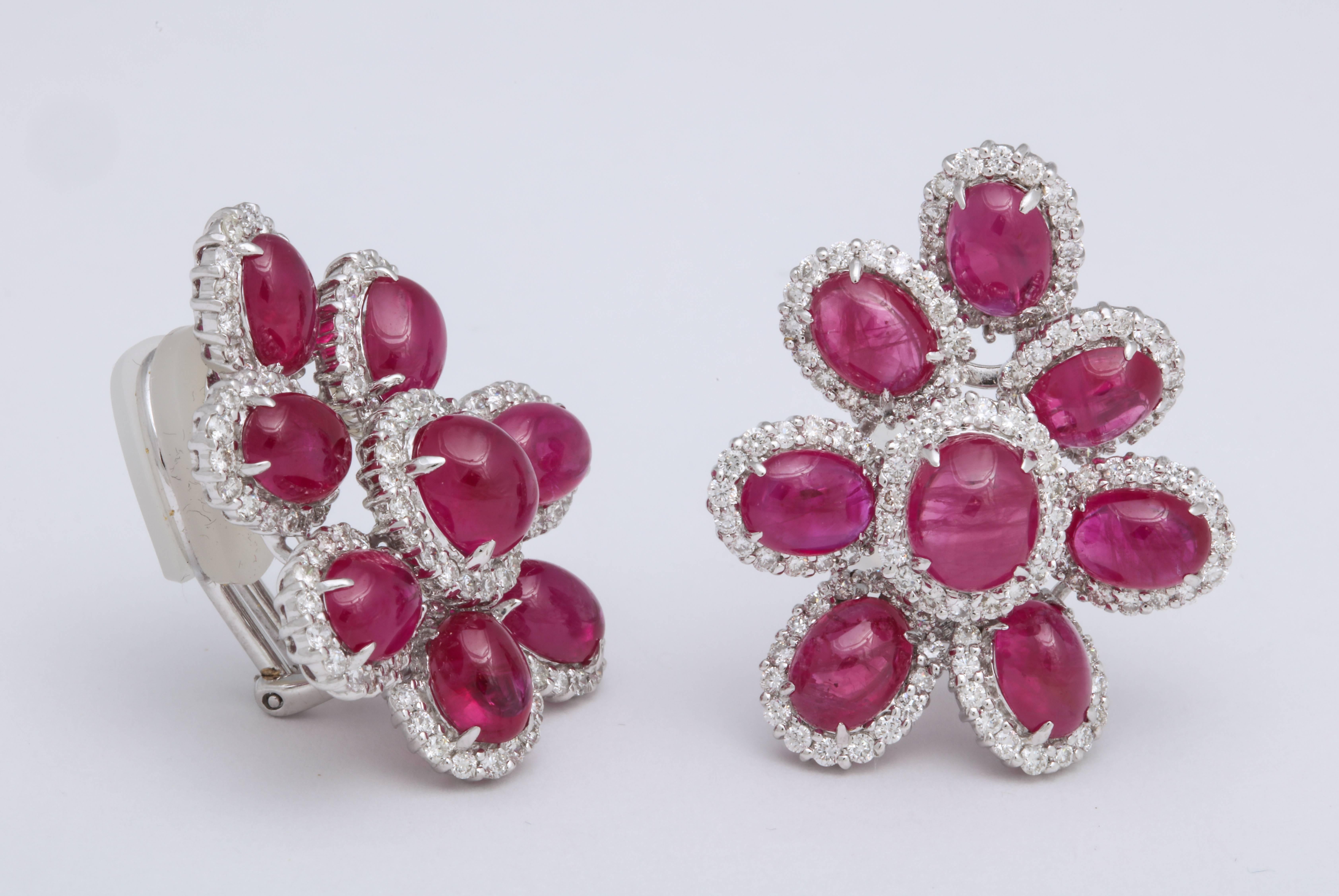 18KT white gold free form cluster of cabochon rubies: 18.99 carats, each ruby is surrounded by prong-set round brilliant cut diamonds: 2.76 carats