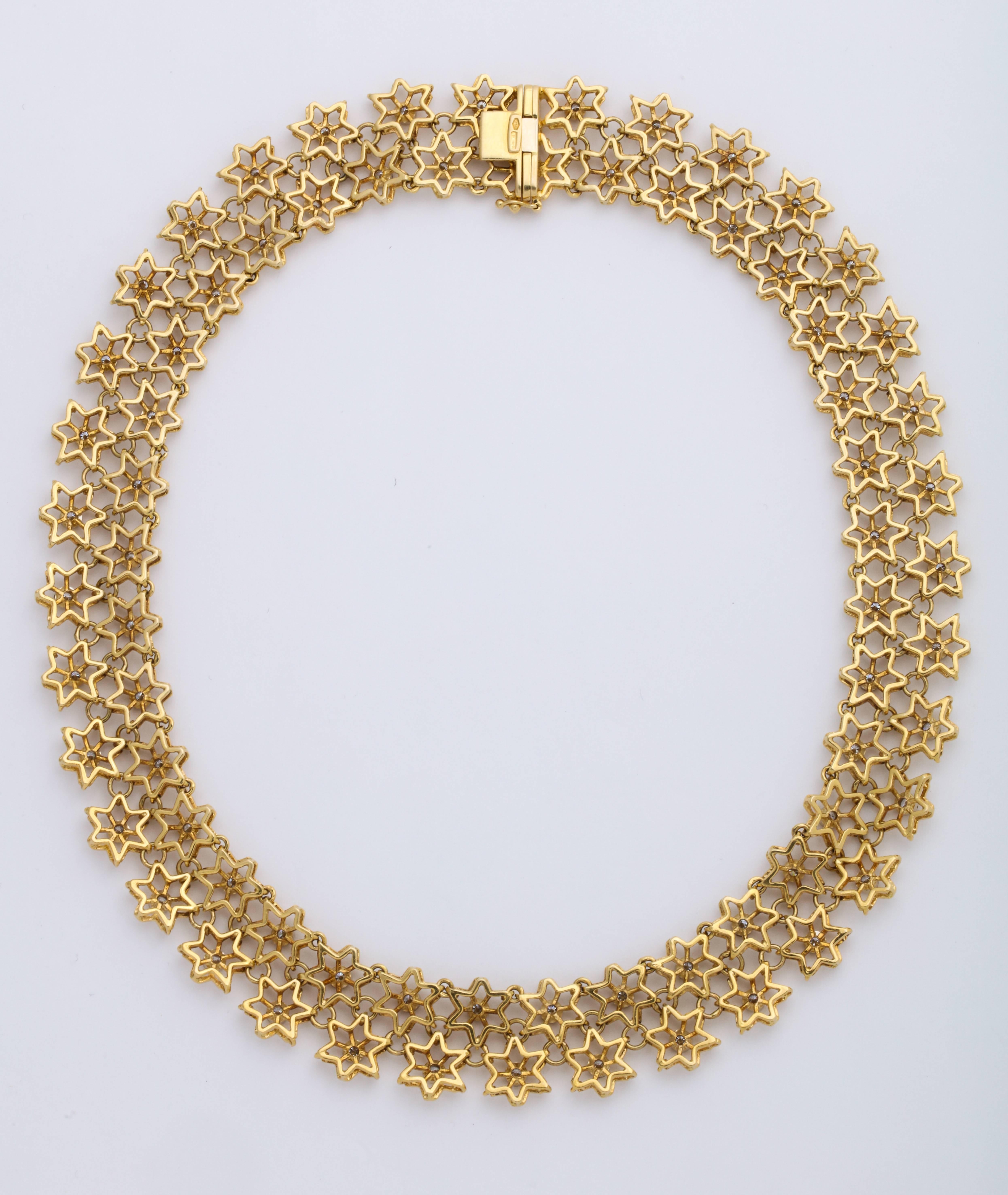 18 Karat Yellow Gold and Diamond Necklace.  This gorgeous golden necklace features twin rows of articulating stylized snowflake cutouts, each decorated with a uniform size, round brilliant-cut colorless diamonds, collect-set, combined weight: 4.45
