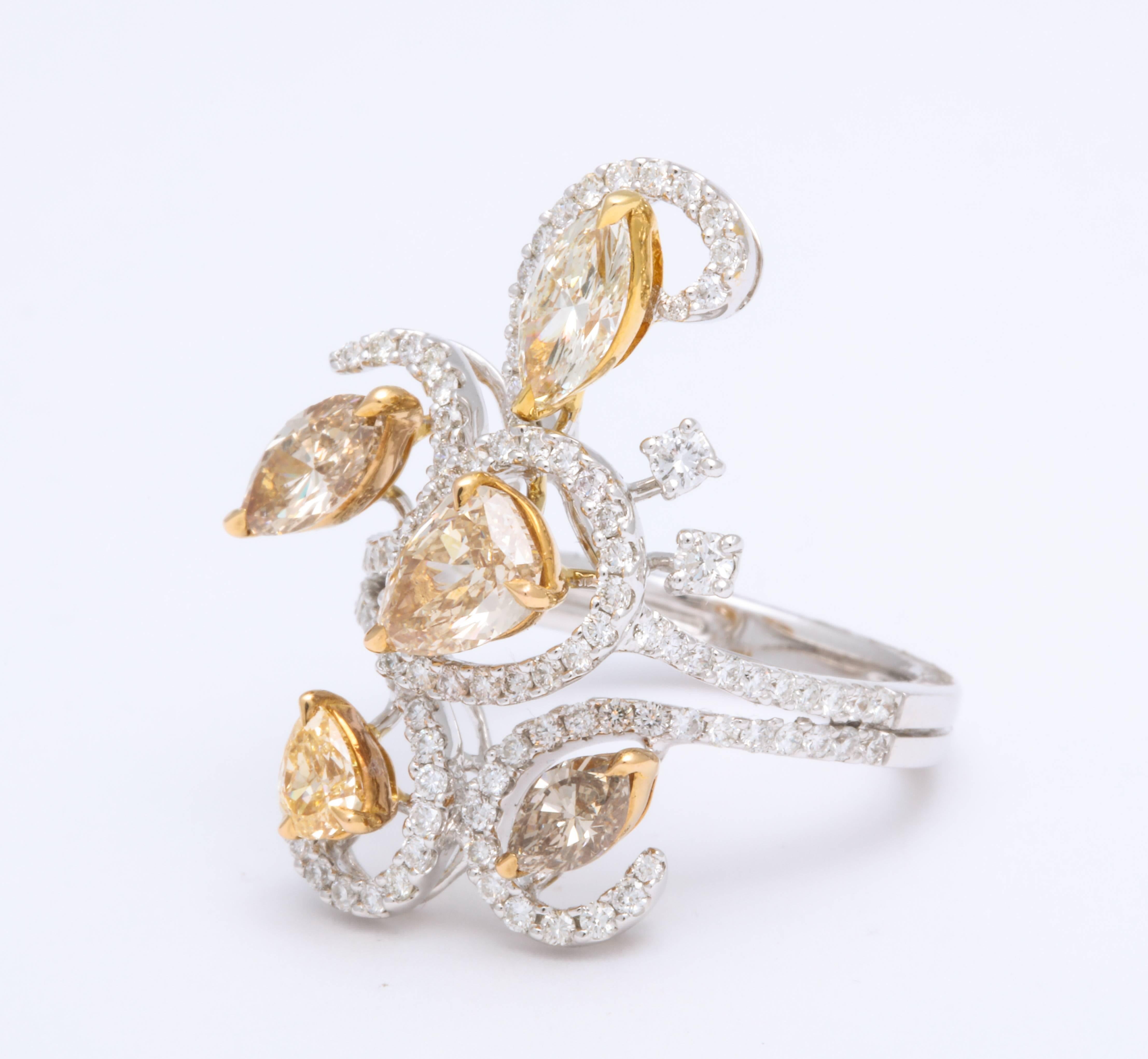 This 18K White Gold Cocktail ring is free form and contemporary, mounted with pear shaped and marquise natural fancy earth tone color diamonds weighing 2.06 carats combined total weight, floating on colorless round brilliant cut diamonds, micro