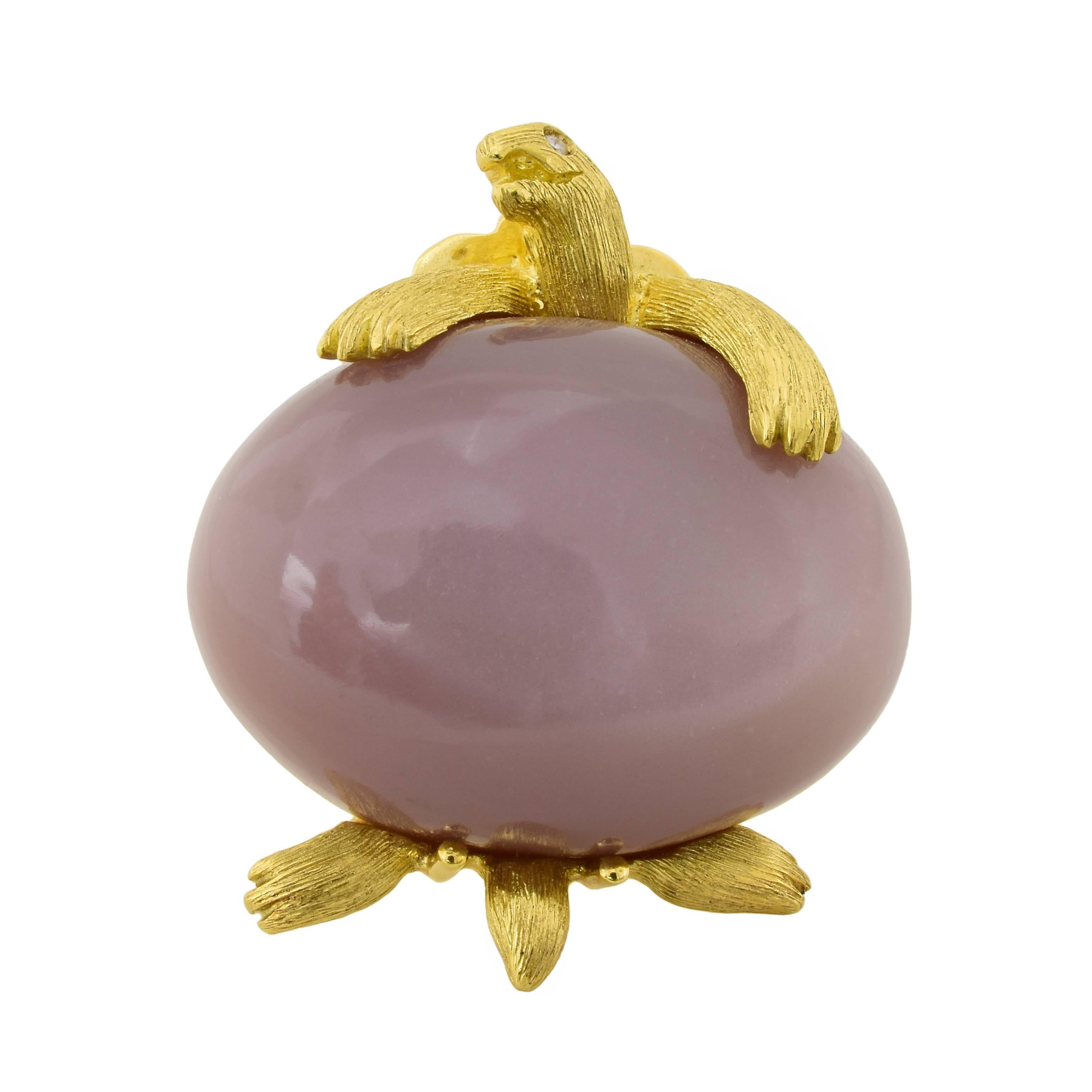 Dunay turtle brooch in 18k yellow gold, featuring a 55.89 carat pink moonstone, which gives off a metallic sheen when reflecting light. The animated face of the turtle has small diamonds for eyes and the texture of his body features Henry Dunay's