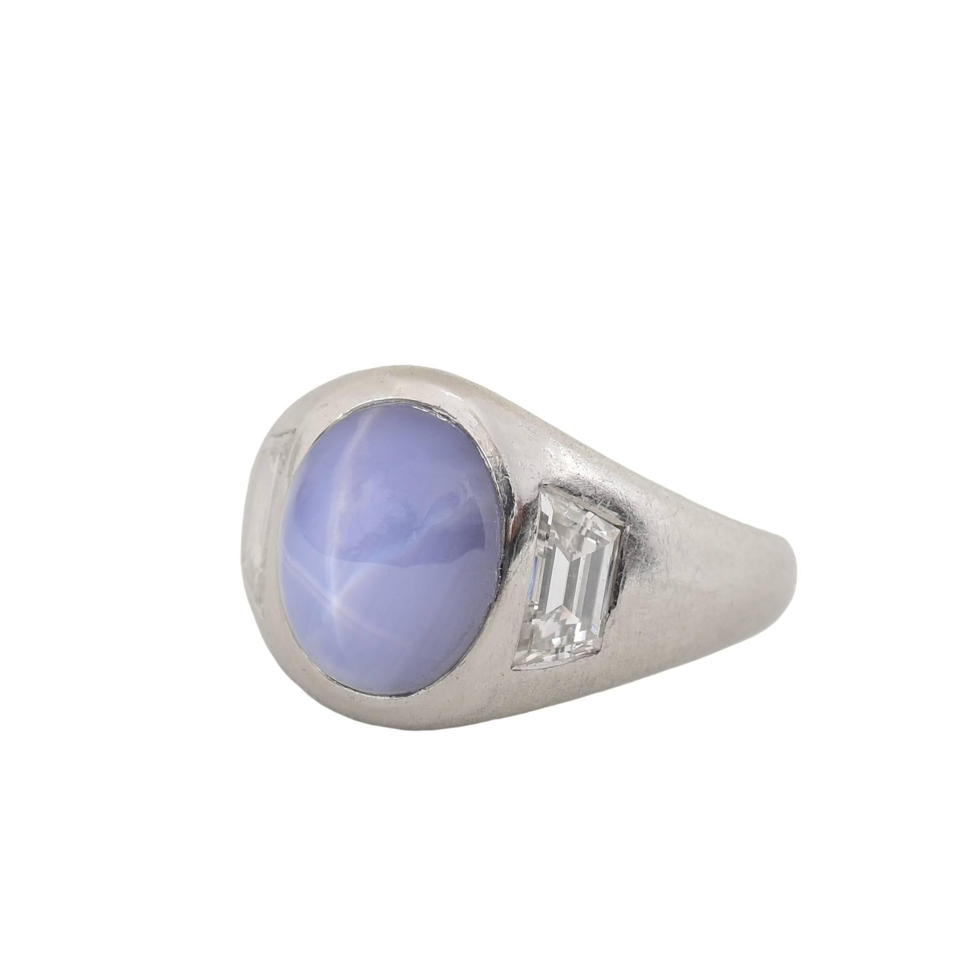 Raymond Yard ring with a star sapphire center and two diamond accents. 