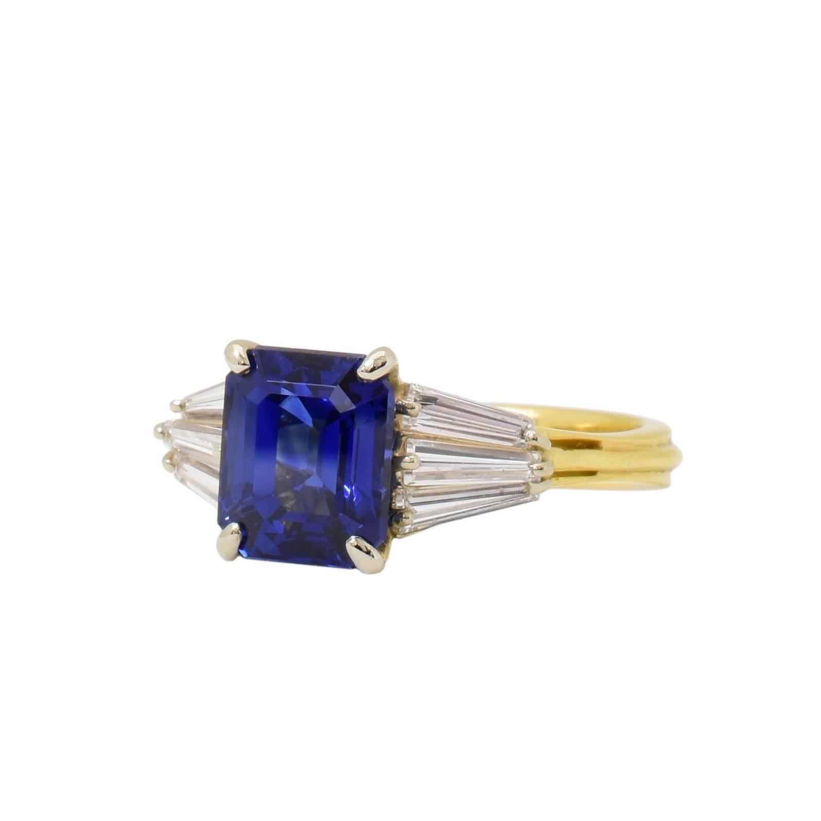 This 18k yellow gold ring features an AGL certified 3.77 carat blue sapphire center stone, with approximately .55 carats total weight of baguette cut diamonds, (3) on each side. The original American Gem Lab certificate is included.