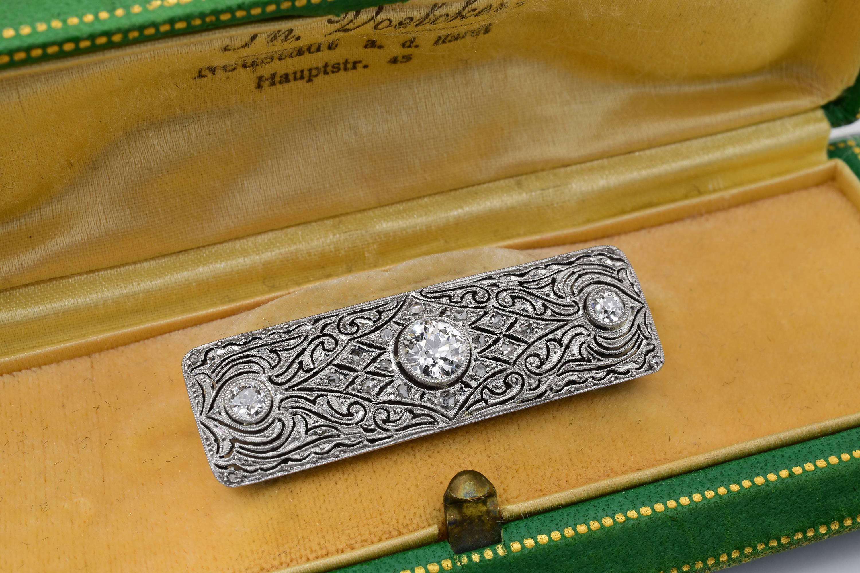 A 1930s deco era platinum brooch, featuring approximately 1.5 carats in diamonds. The brooch fastens flawlessly with a trombone push-pull clasp, common from the 1850s to 1940s. The brooch comes with the original box, which latches and closes and is