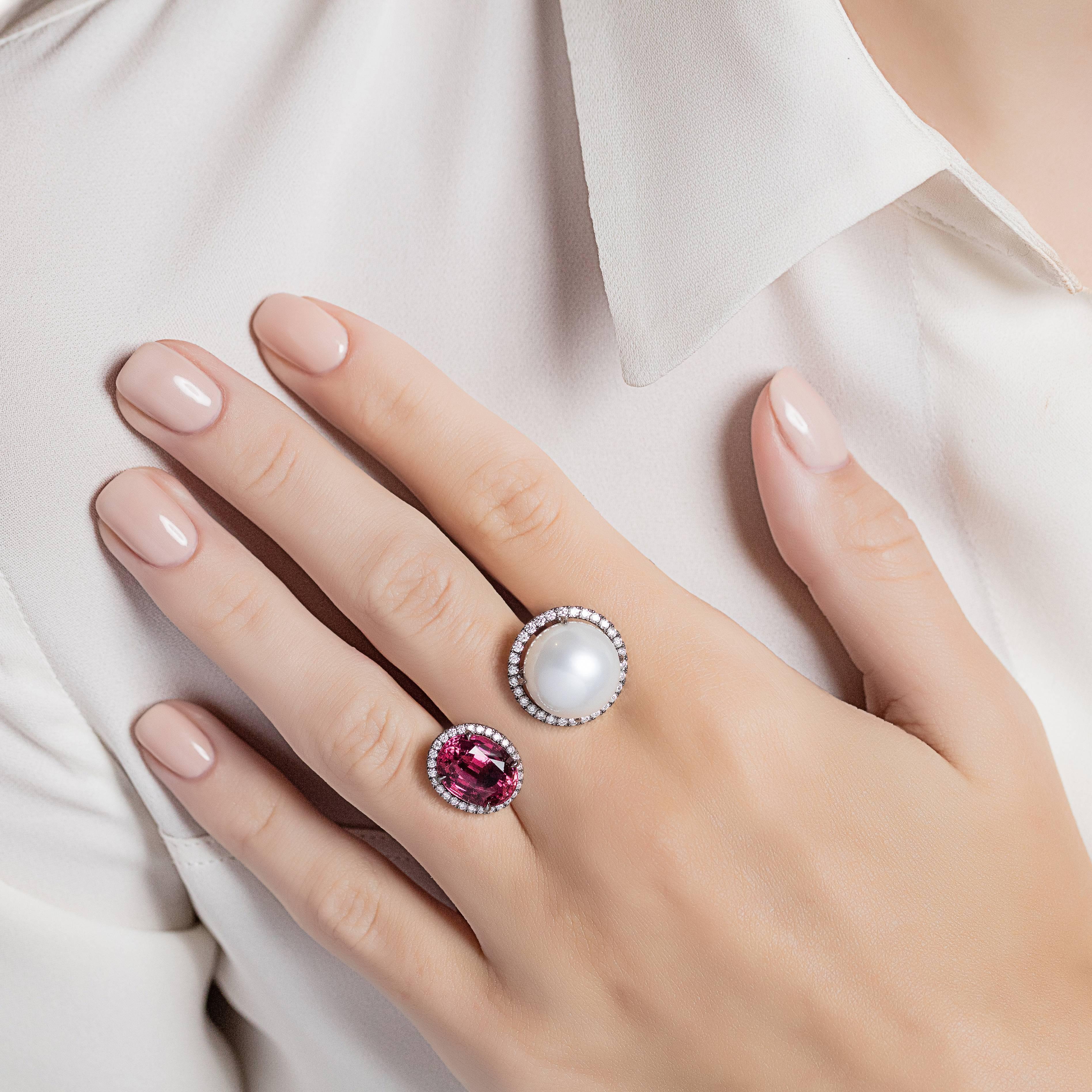 A striking between the finger ring made from 18K grey gold with rubellite and a white south sea pearl, each surrounded with diamonds. Parti of Elle et Lui collection, which symbolises the interaction of extremes – men and woman – which formed the