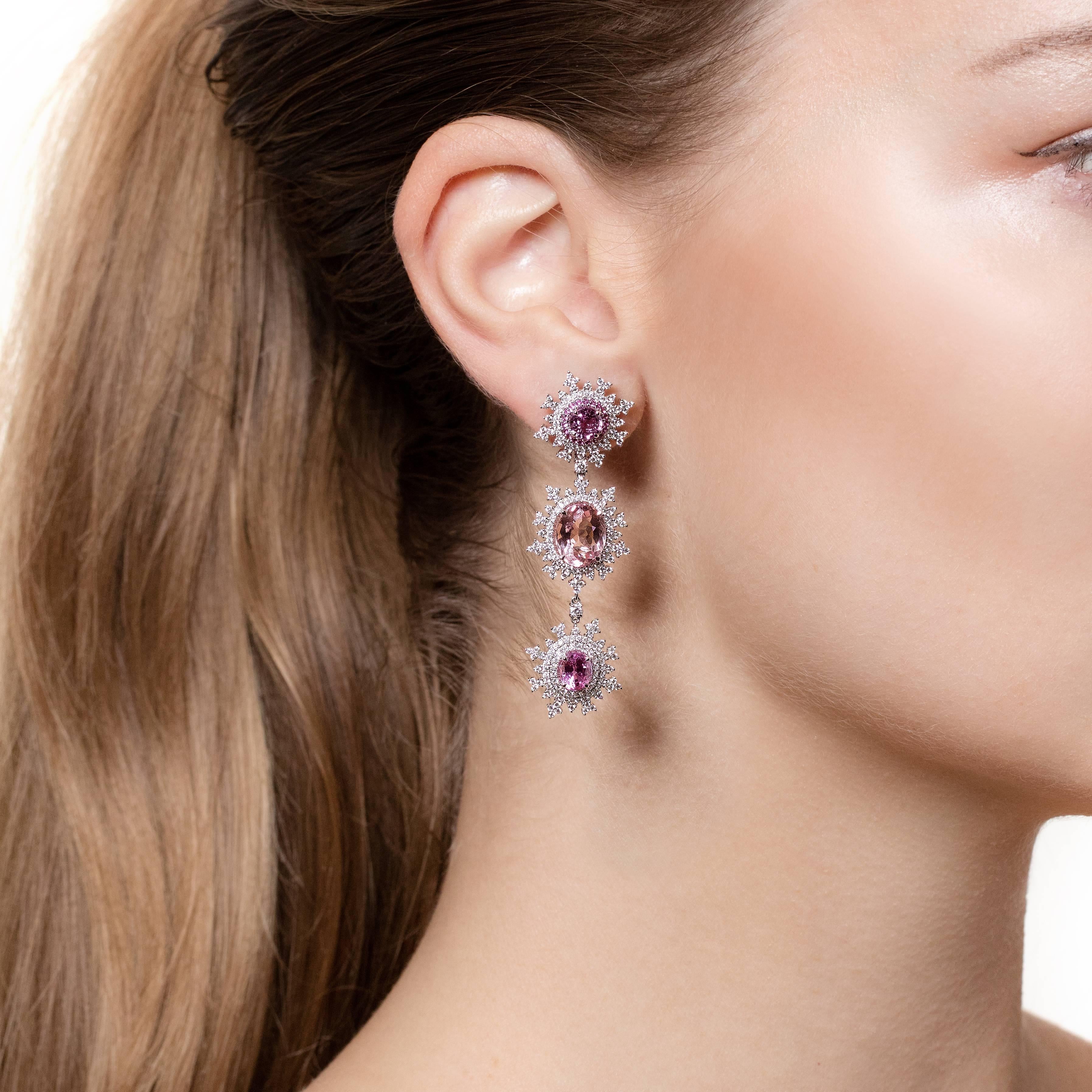 Detachable Earrings in 18K white gold (16.0g), 4 pink untreated sapphires 3.00ct., 2 oval morganites 7.0 ct., 38 round-cut sapphires 1.24ct., 506 white round-cut diamonds 1.85ct.

A stunning pair of long detachable flake earrings that are made from