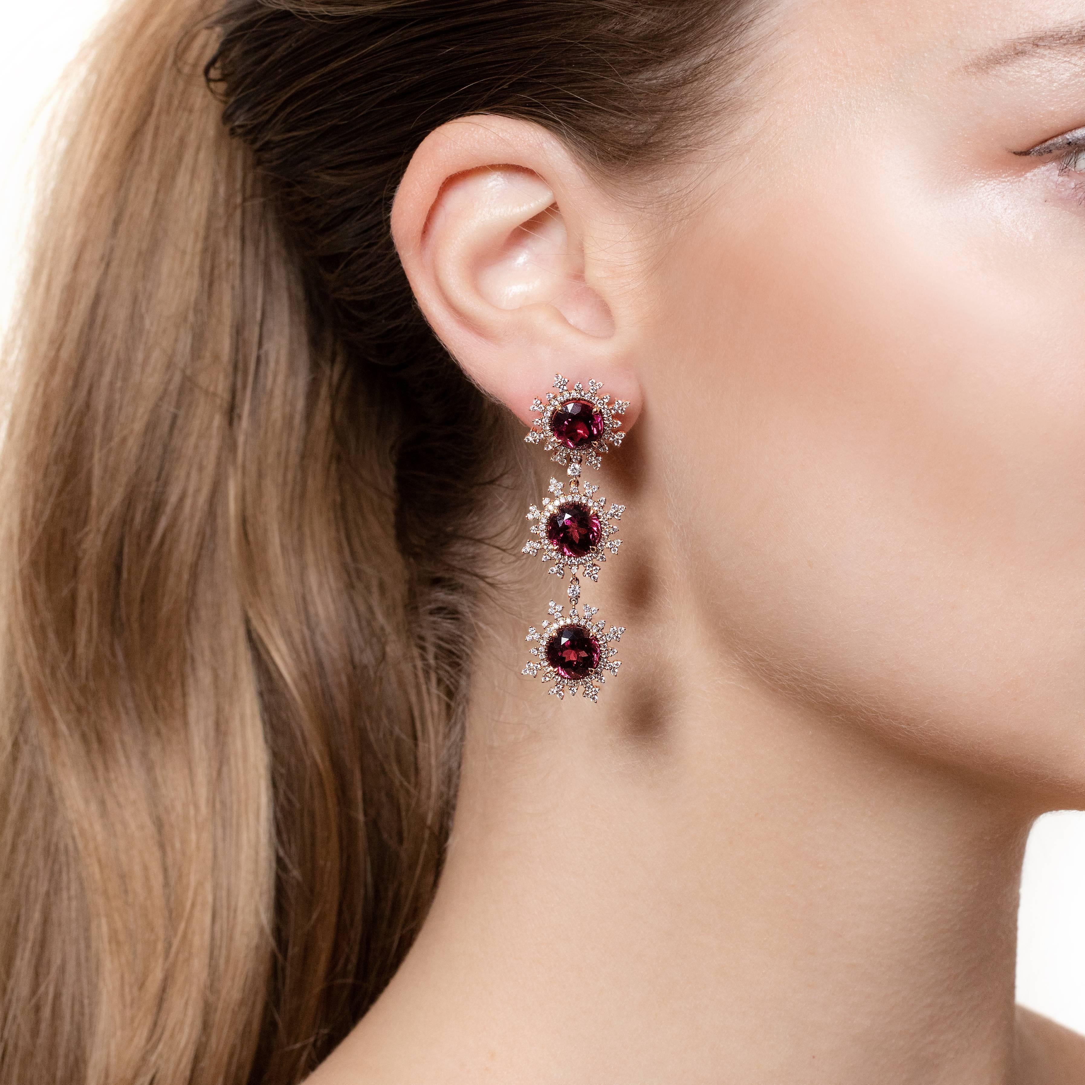 18ct. rose gold (12.0g), 6 red rhodolite 14.6ct., 388 white round-cut diamonds 1.62ct.

A stunning pair of long detachable flake earrings that are made from 18ct. rose gold with 3 raspberry red rhodolite stones on each earring that are surrounded by
