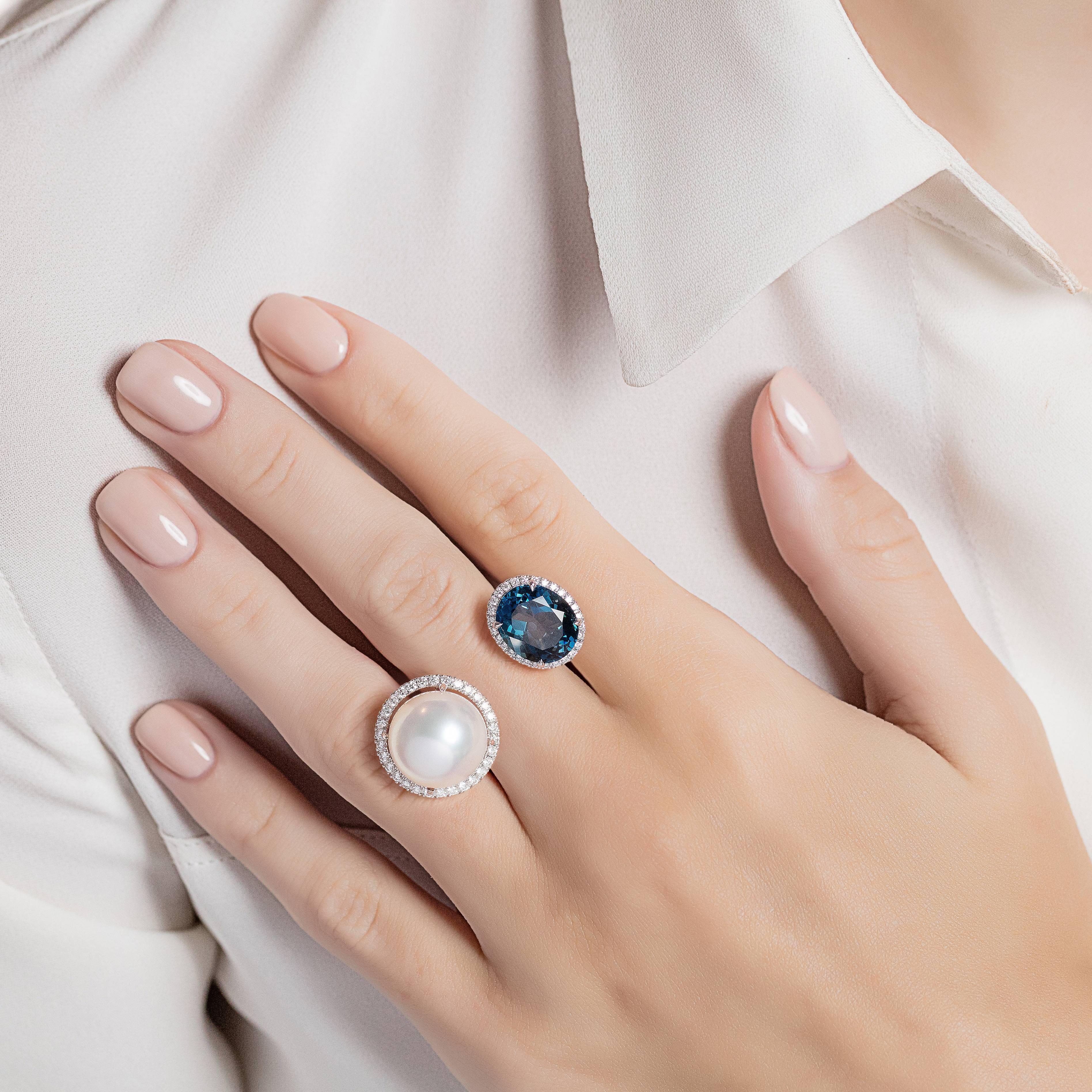 A striking between the finger ring made from white gold with blue topaz and a white south sea pearl, each surrounded with diamonds. The Elle et Lui collection symbolises the interaction of extremes – men and woman – which formed the basis for the
