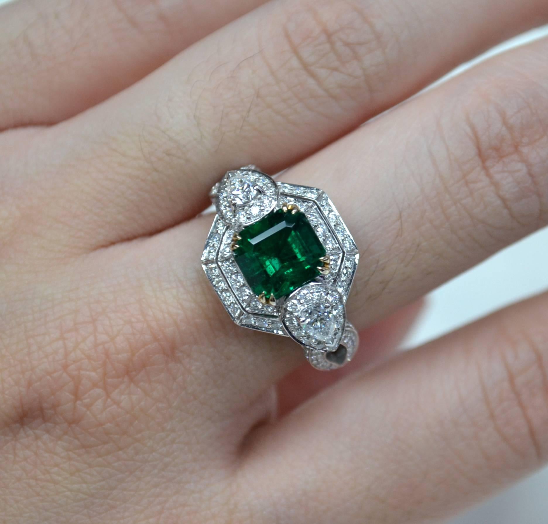 Ring in 18 karat two-tone gold set with an intense green emerald cut Zambian Emerald (2.00 carat), 2 pear-shaped Diamonds and round brilliant-cut Diamonds (1.22 carats).

Ring US Size 6.5
*Complimentary resizing service*