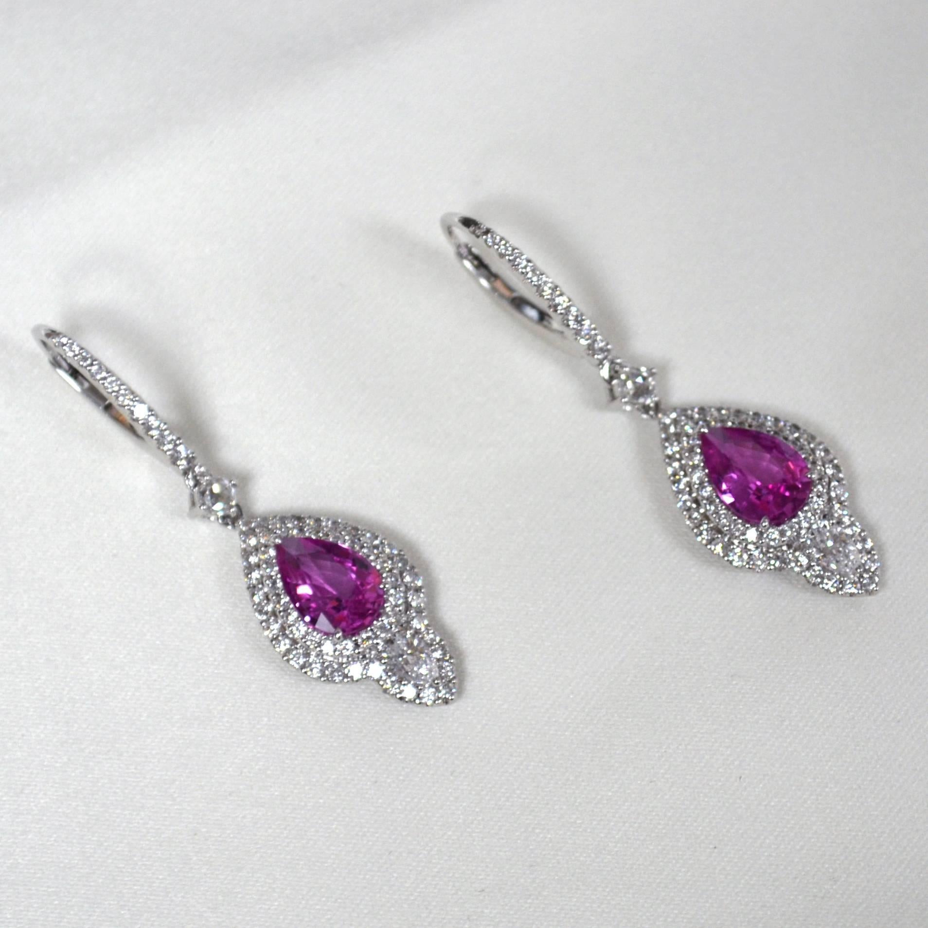 Earrings with lever back closures in 18 karat white gold set with 2 pear-shaped 9x6 mm Madagascar Pink Sapphires (2.55 carats), 2 pear-shaped Diamonds (0.35 carats), and 130 round brilliant-cut Diamonds (1.17 carats).
