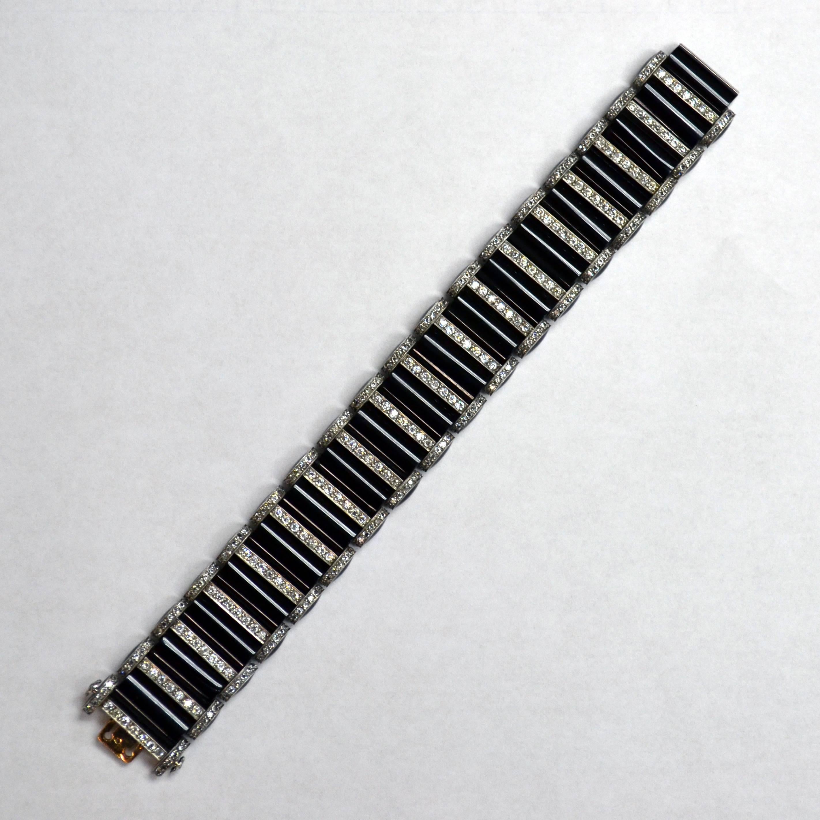 Bracelet with box clasp closure in platinum, set with onyx segments, old european-cut diamonds spacing (5.00 carats), and black enamel sides.

Length of bracelet: 7 inches. 
Partial maker's mark, French assay mark. Circa 1920. 