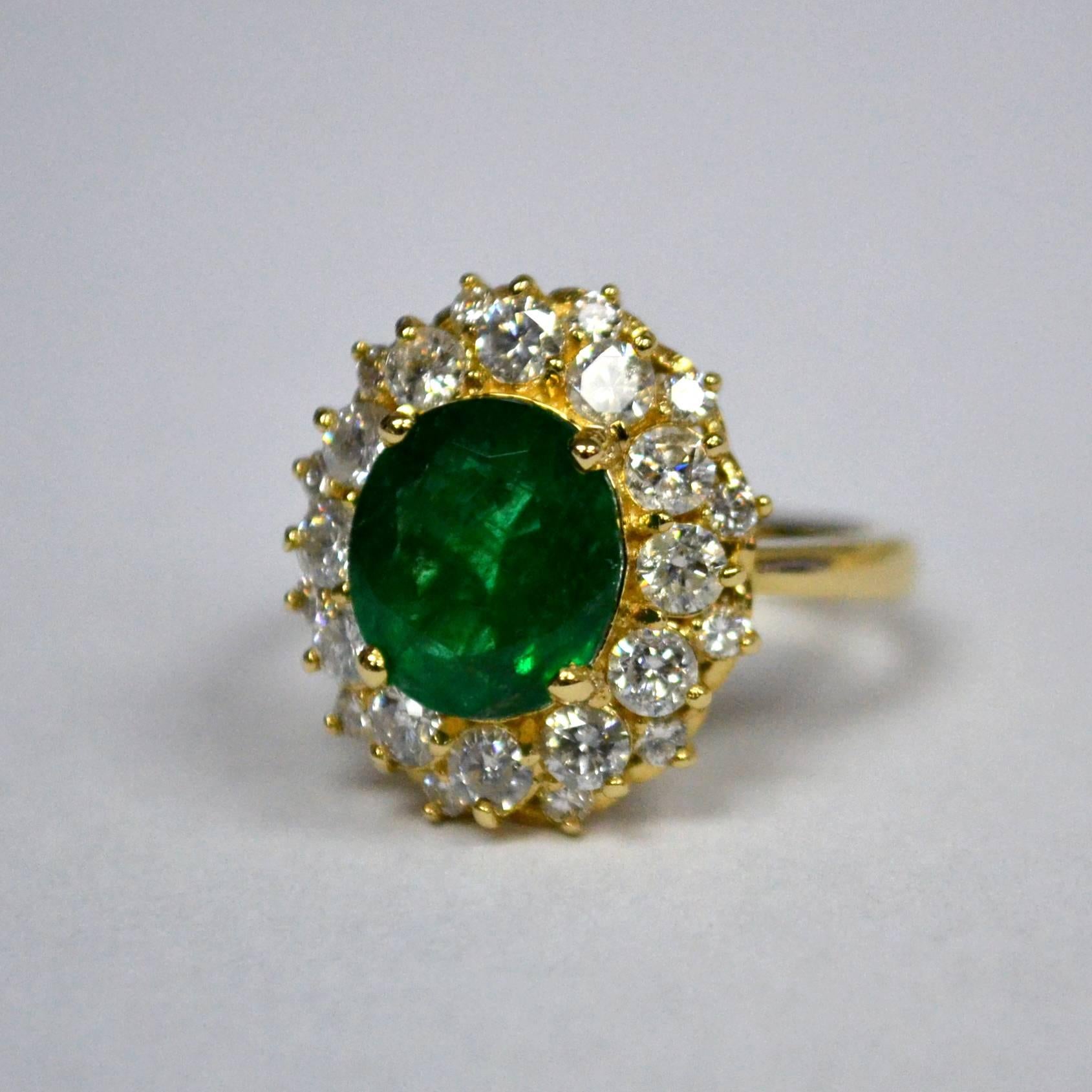 Princess Diana style engagement ring in 14 Karat yellow gold set with one oval cut Zambian Emerald (3.17 carat) and 24 round brilliant-cut Diamonds (1.44 carats).

Ring US Size 7.5 
*Complimentary resizing service*