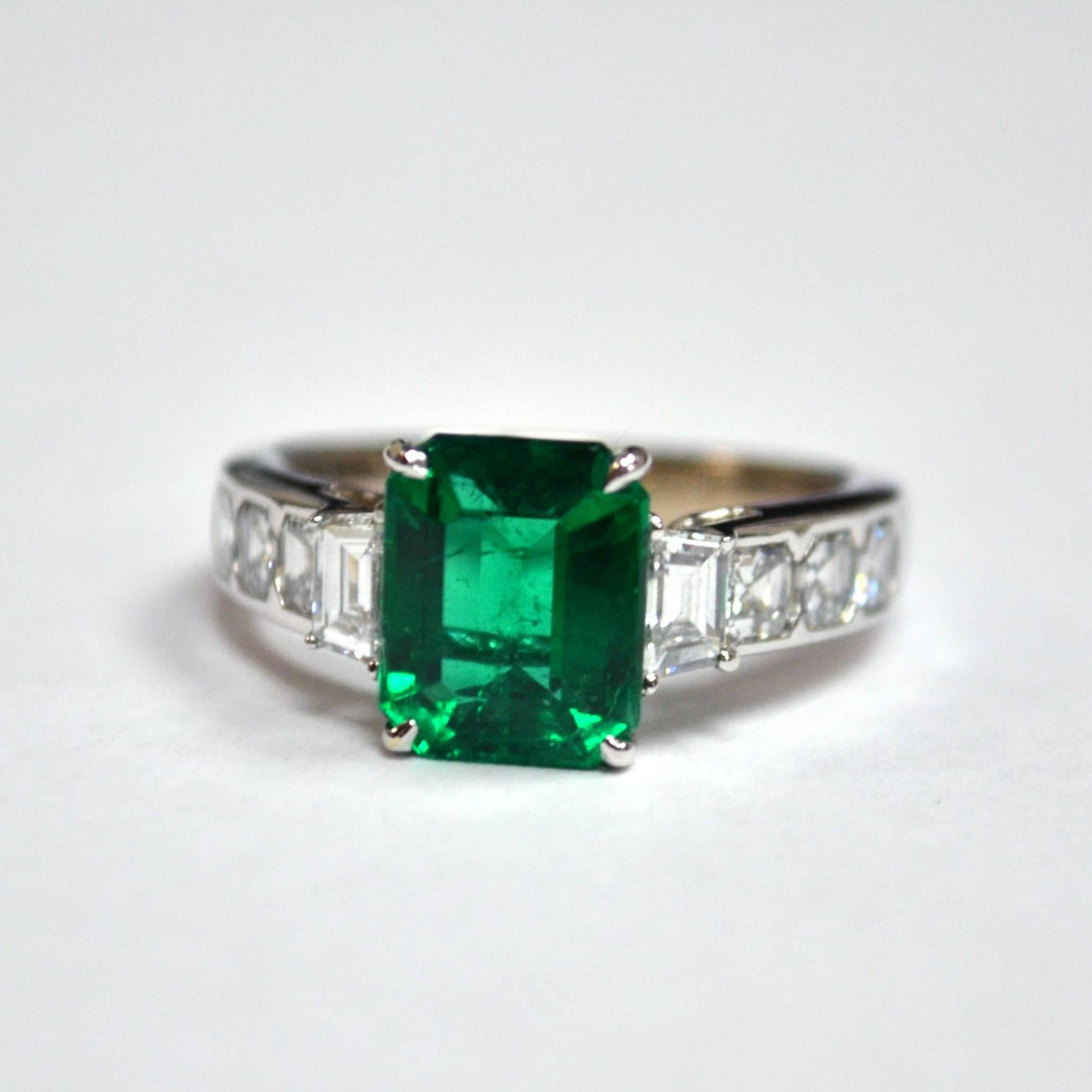 Ring in 18K white gold set with an emerald cut Zambian Emerald (2.36 carat), 2 trapezoid cut Diamonds (0.33 carat), and 8 asscher cut Diamonds (1.34 carat).

Ring Size US 6.5
*Complimentary resizing service*