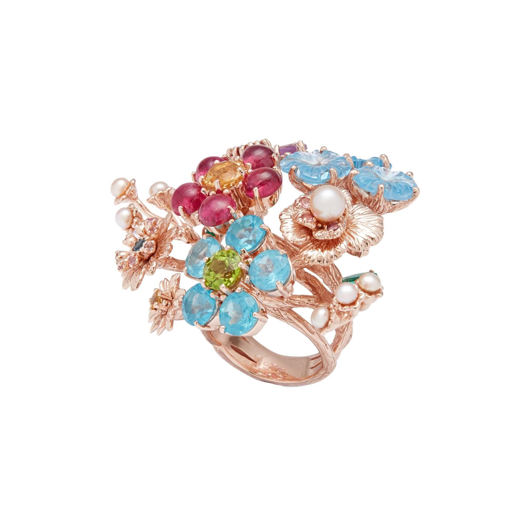 In the manner of a bouquet, one of a kind Matina Amanita Elizabeth 14K pink gold crafted Ring, is distinguished by the airy movement of its petals. Forget me nots' luster is conferred by round cabochon sky blue topazes, a peridot bud as well as pink