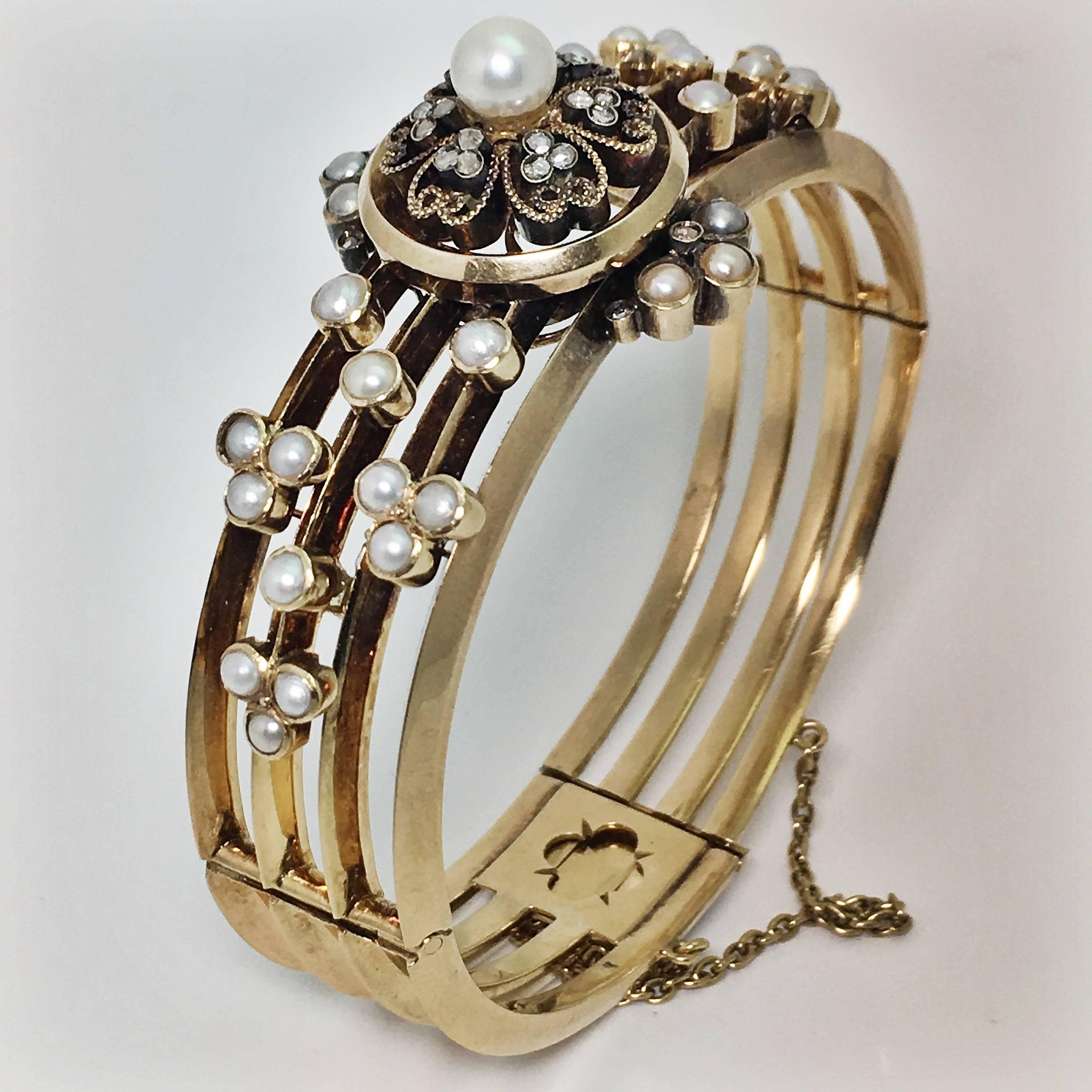 A french antique pearl and diamond yellow gold hinged bangle. This bangle would have been made in the late 19th century.The structure of the bangle consists for bands of hollow yellow gold crafted beautifully into shape with a secure clasp and