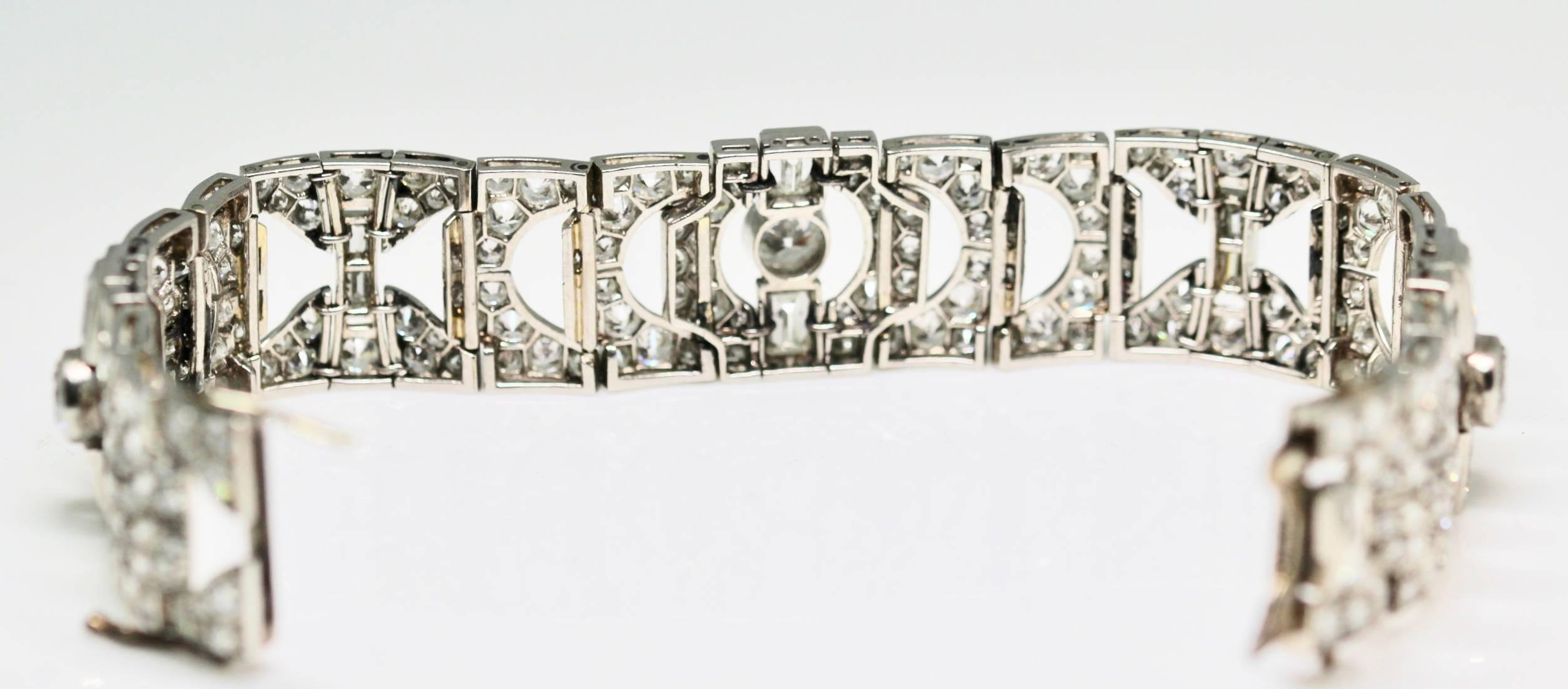 A fabulous condition 1930's platinum Art Deco diamond bracelet with estimated 22 carats of diamonds.  The bracelet is composed of  diamond studded geometric motifs spaced with openwork links to a concealed clasp. The platinum bracelet is set with