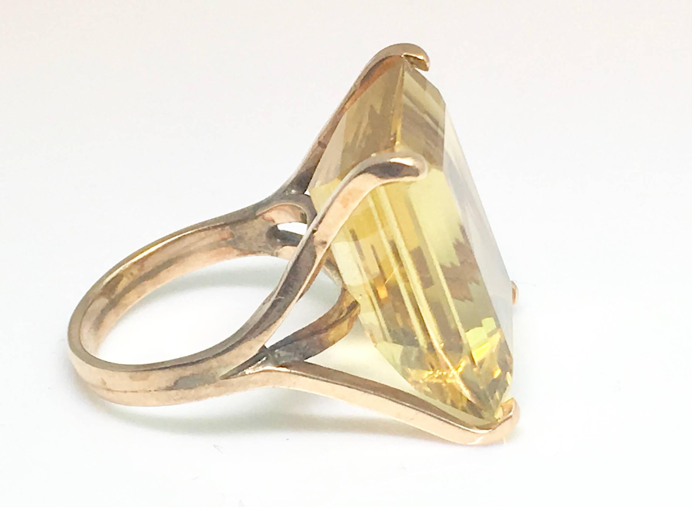 A Large Citrine emerald cut single stone french cocktail ring. Approximately 20 carats 