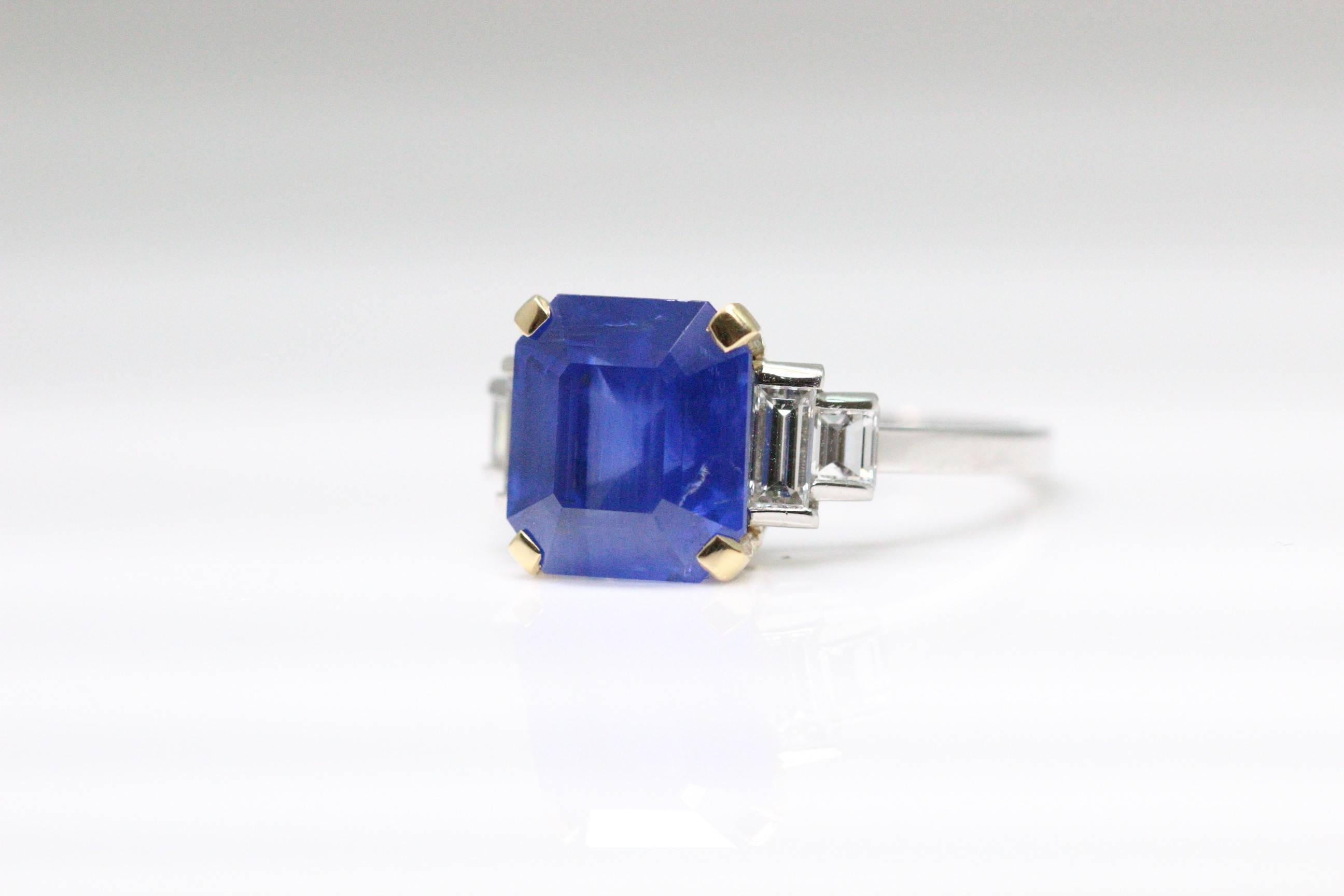 A Bulgari ring mounted with cornflower blue octagon sapphire weighing 6.54 carats, certified by SSEF. The central stone has baguette diamond shoulders leading to a slender shank.  The sapphire is natural and the origin is Sri Lankan.  The ring size