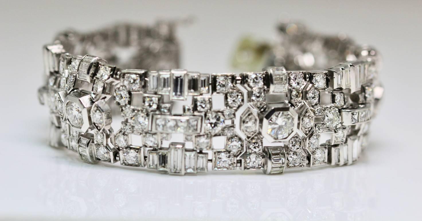 This fine Retro Platinum diamond bracelet has approximately 28 carats of diamonds. This bracelet comprises of  round, baguette and scissor cut diamonds set in platinum. This a splendid example of 1940's Retro design, we have remember each piece of