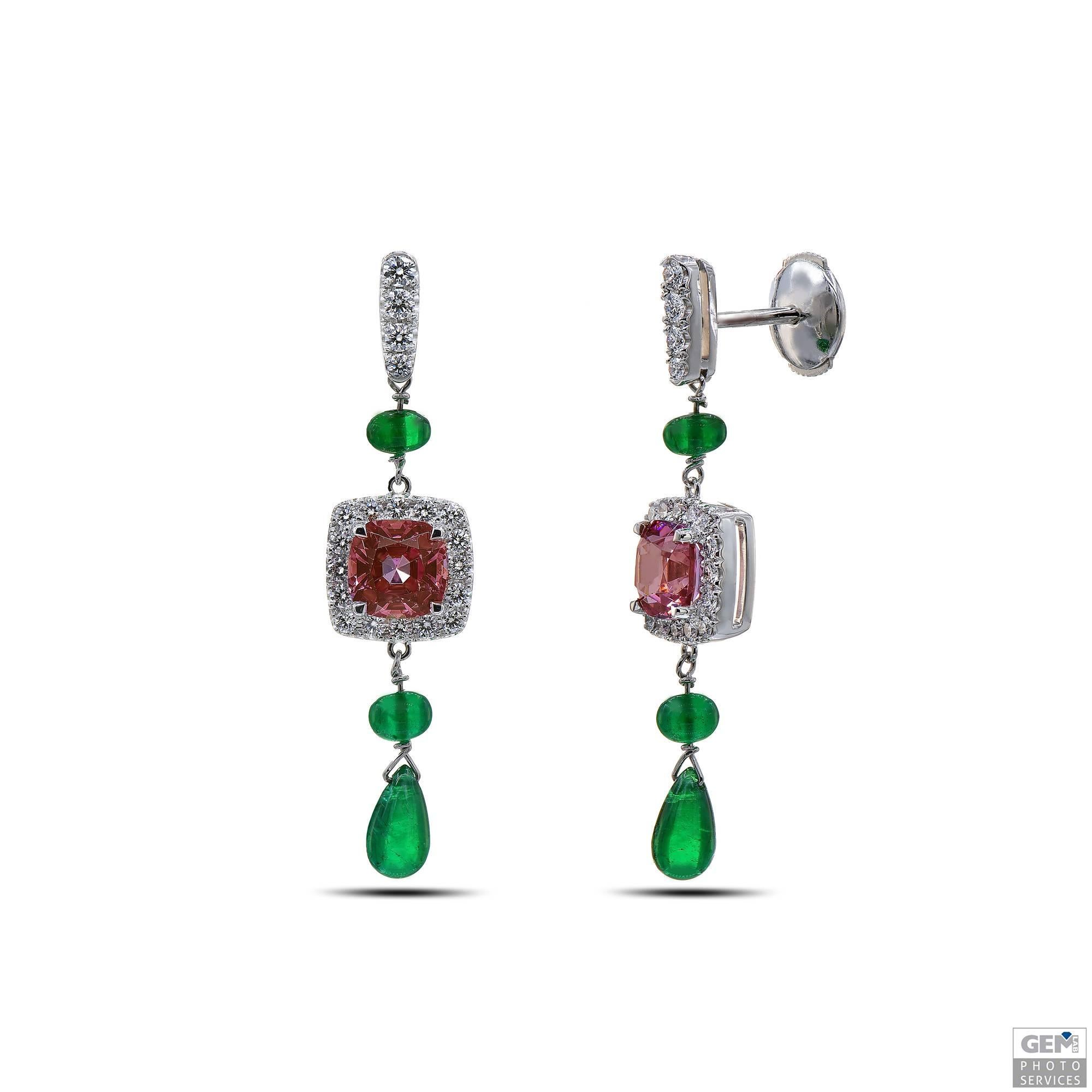 Very fine and colorful drop earrings by Carigi. The central cushion cut gemstones used for this design, are a perfect couple of Malayan Garnet with a combined weight of 3,03 carat. The color is very unique. It has shades of red, brown, pink and