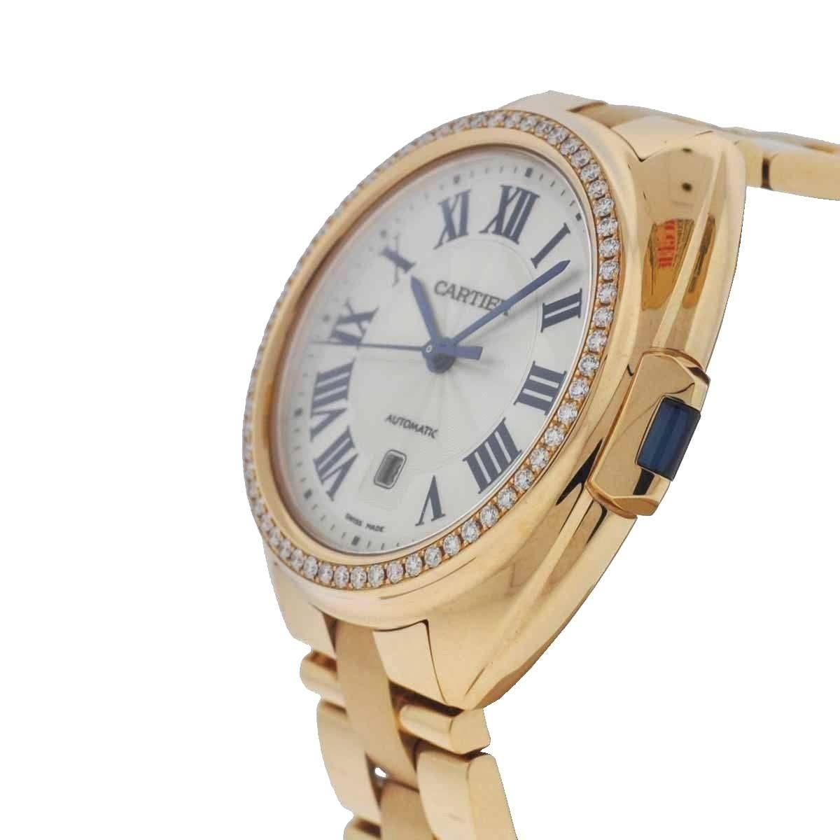 Company - Cartier
Model - Cle de Cartier WJCL0003
Case Metal - 18k Rose Gold
Case Measurement - 35mm
Bracelet - 18k Rose Gold with Double Deployment Clasp
Dial - Silvered
Bezel - 18k Rose Gold Fitted with Factory Original Diamonds
Crystal - Scratch