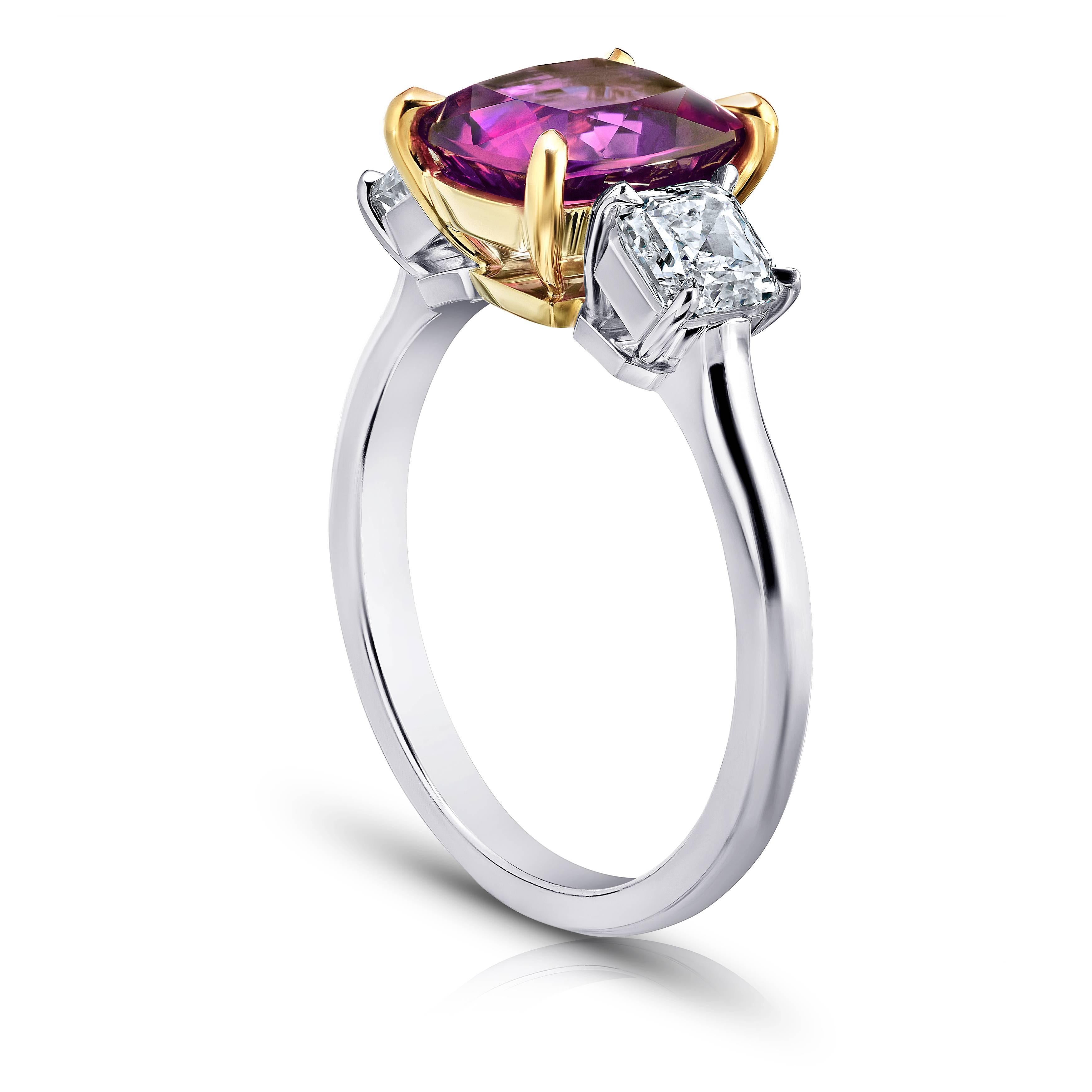 This meticulously crafted ring has a center Cushion Pink Sapphire weighing 3.29 carats with two Radiant cut diamonds (G/VS1- VS2) weighing 1.09 carats. All set in platinum and 18k yellow gold basket.
The center stone is total clean and has a great