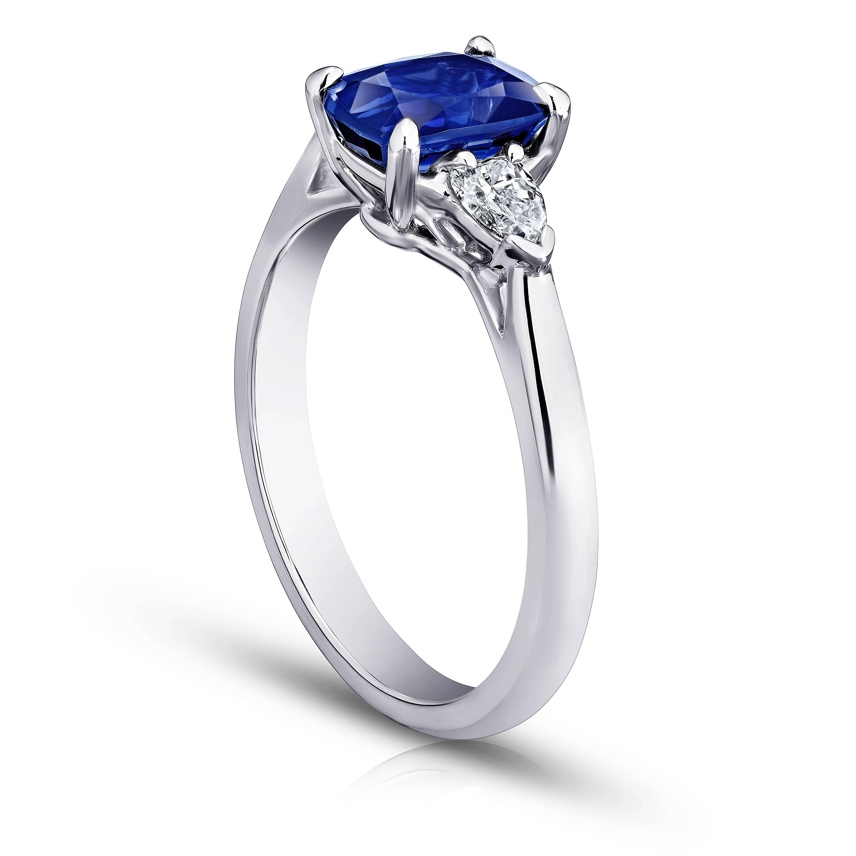 This blue sapphire ring is impeccable. Its center stone is a natural no heat vivid blue sapphire weighing 1.88 carats. The stone is perfectly cut and extremely clean with great  color saturation. Two shield cut diamonds weighing .36 carats (F+ VS+) 