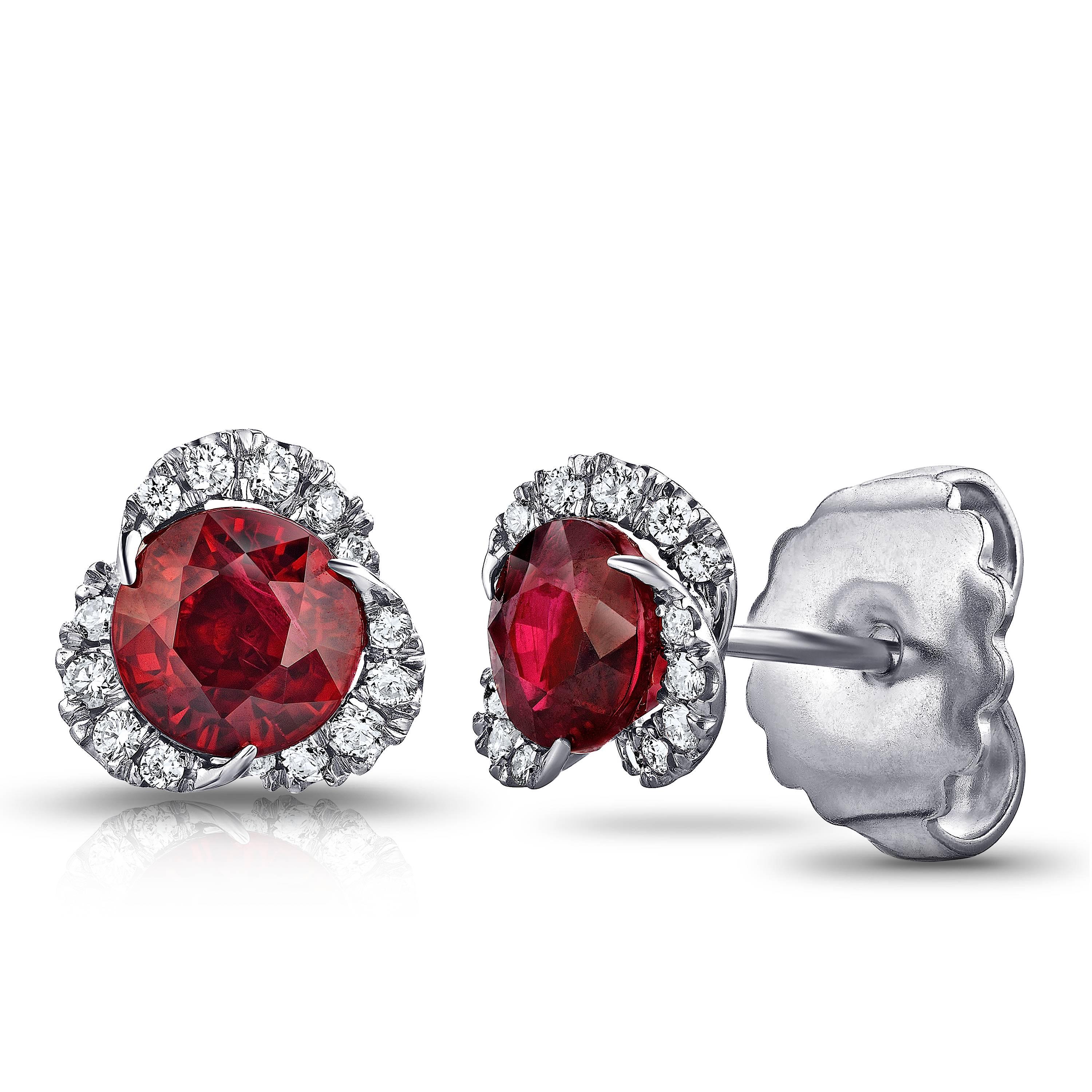 Two round  red rubies weighing 2.46 carats set with 30 round diamonds weighing .22 carats (F+ VVS/VS+). Set in hand made platinum. Only the finest quality stones and workmanship was used to create this impeccable  pair of earrings. The tops of these