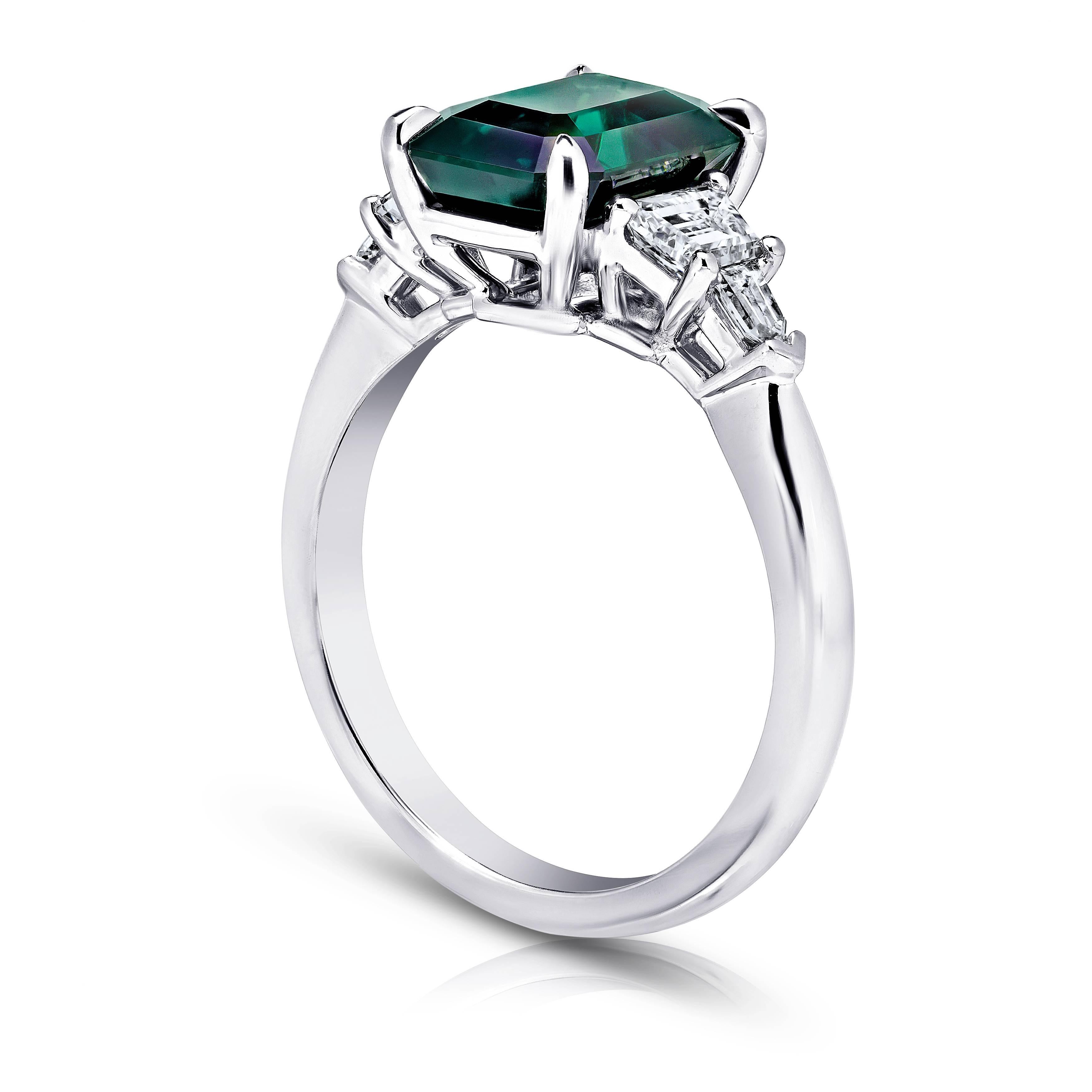 This meticulously crafted ring has a center Emerald Cut Green Sapphire weighing 3.83 carats with two trappazoid and two bullet shape diamonds (F+ VS1+) weighing .68 carats. All set in platinum ring.
The center stone is total clean and has a great