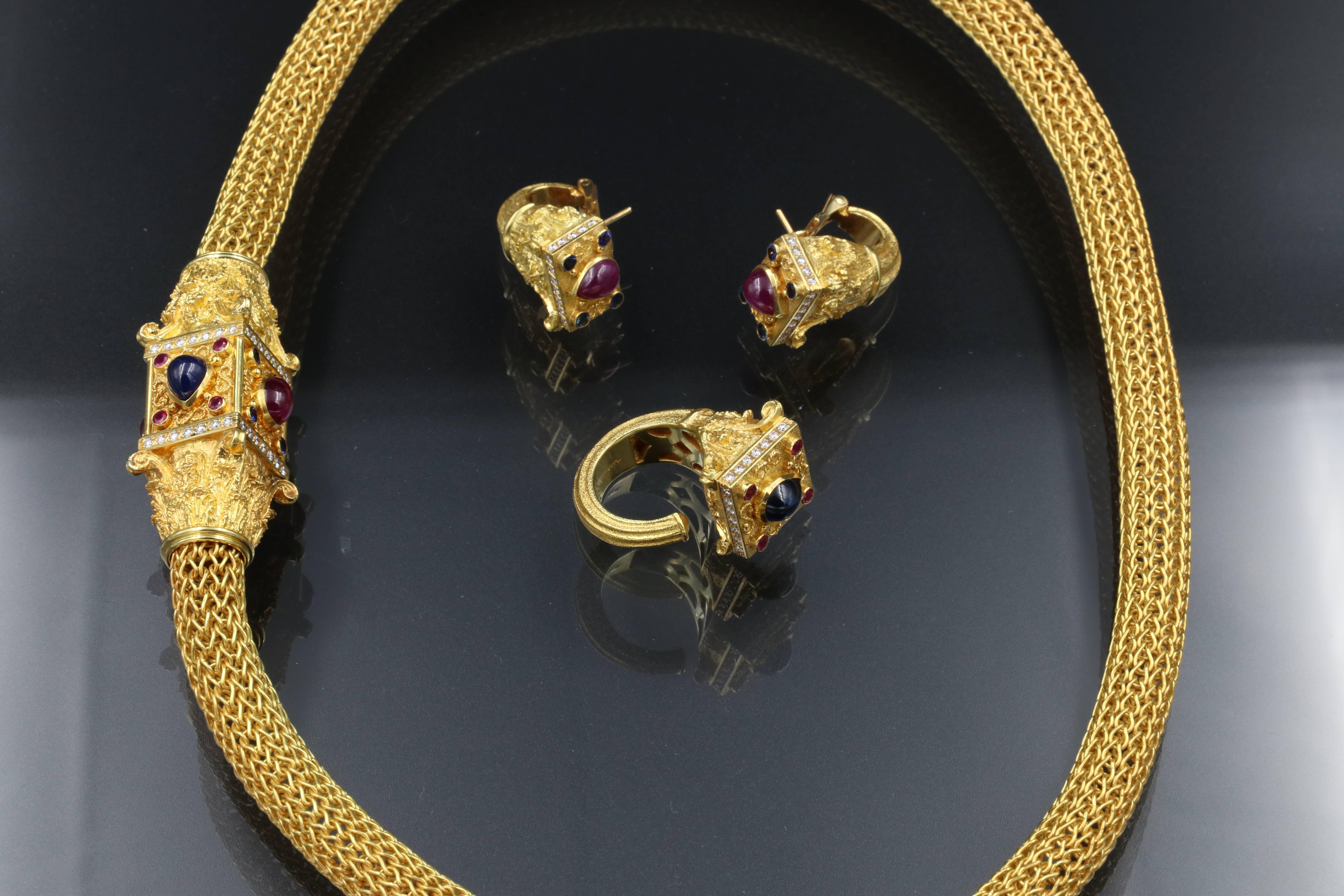 Beautiful and spectacular 18k gold, diamonds, rubies and sapphires cabochon set. 
The Necklace has a snake mesh, the clasp has a 