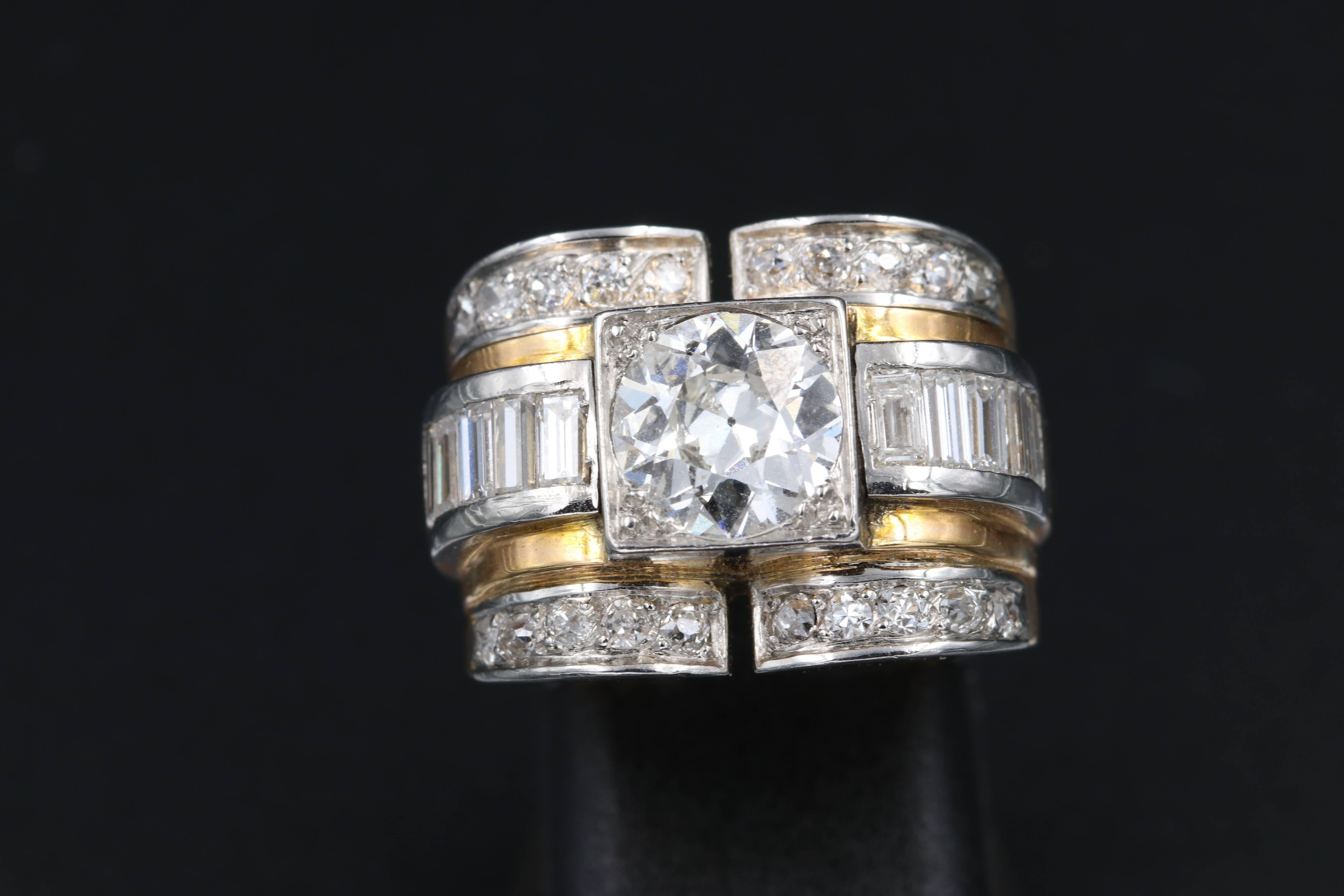 Beautiful tank ring French made circa 1940. Gold, platinum and diamonds. The central diamonds weights approximately 1.40 carats, the quality is H/I colour estimate and the clarity Vs. 
The other diamonds weights approximately 1.8 carats.
Total