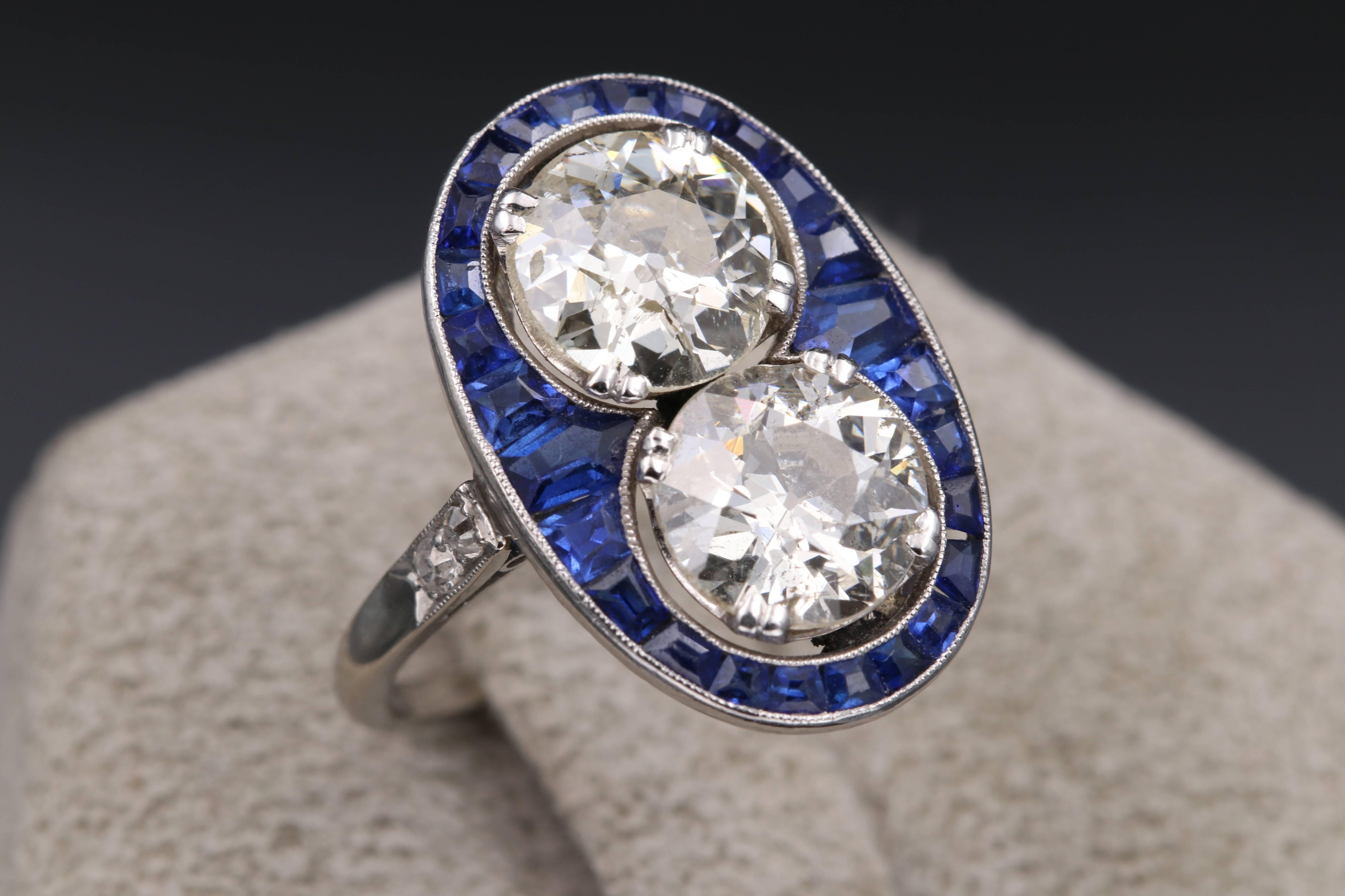 Beautiful and elegant toi et moi ring. French made circa 1920, Made of platinum, natural sapphires calibrés ans two diamonds. This design is exquisite and unique. 
The diamonds weights approximately 1.80 /2 carats each. 
The color is I/J and the