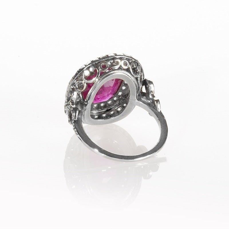 An Antique English Burmese ruby ring set in  platinum and surrounded by 56 double rows of old European cut diamonds approximate total weight of .85 carats.The center oval-cut Burmese ruby weighs 5.26 carats. The ring is decorated with diamond
