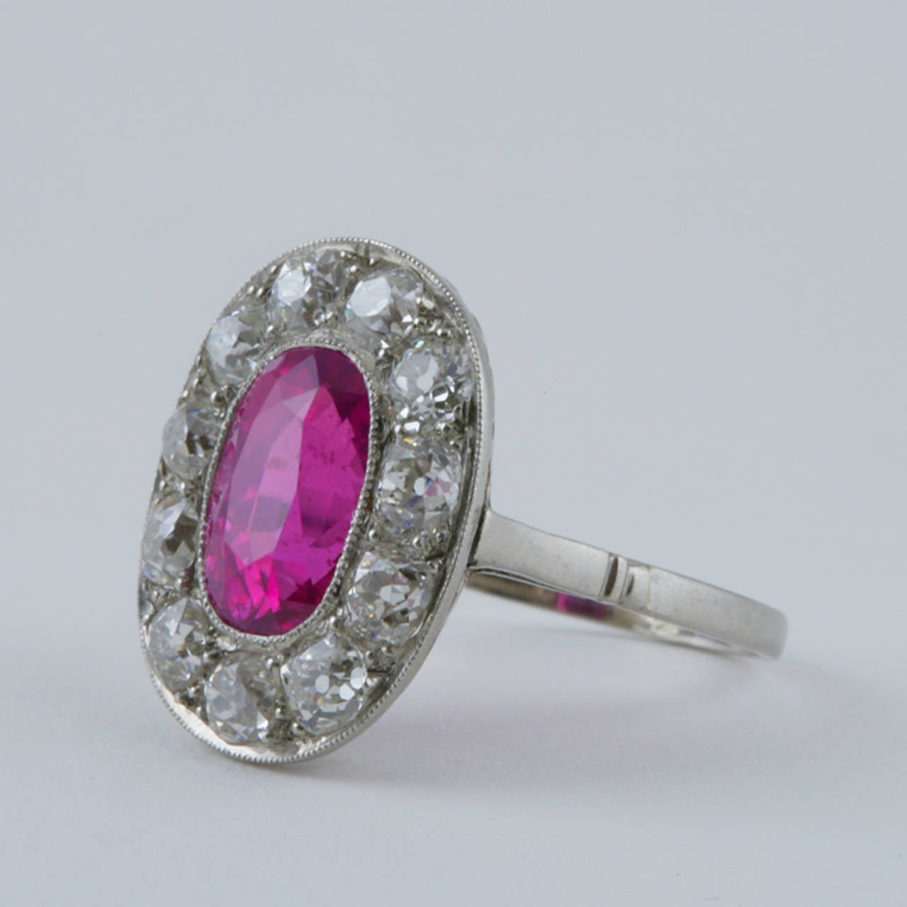 This Belle Époque French ring features a nearly four-carat vivid pink Ceylon sapphire, framed by a halo of fiery old mine-cut diamonds. The pink sapphire’s brilliance is ideally showcased by the delicate platinum work of the bezel, and scrolling